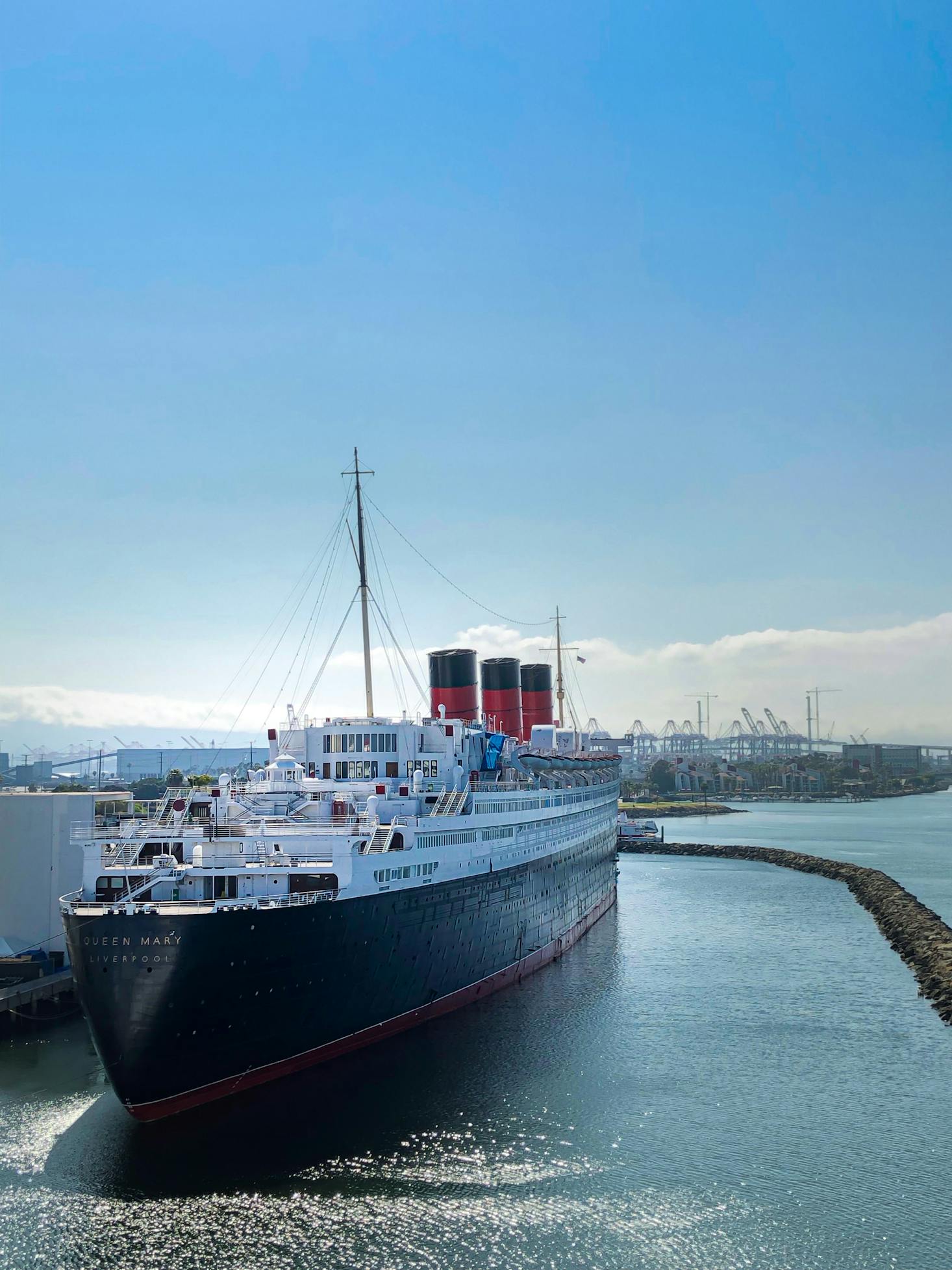 The Queen Mary boat docked in Long Beach on a sunny day