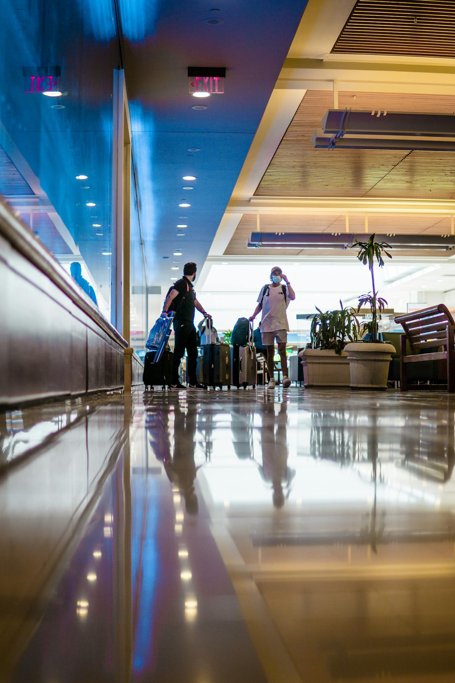 People with luggage waiting for a flight at Orlando International Airport