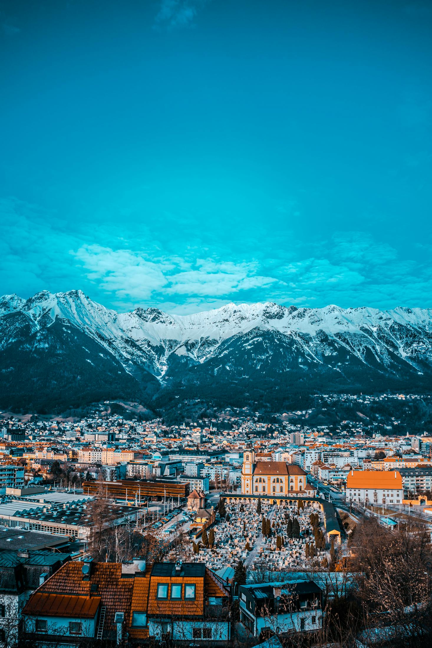 Wide view of the city of Innsbruck with snow-capped mountains in the surroundings