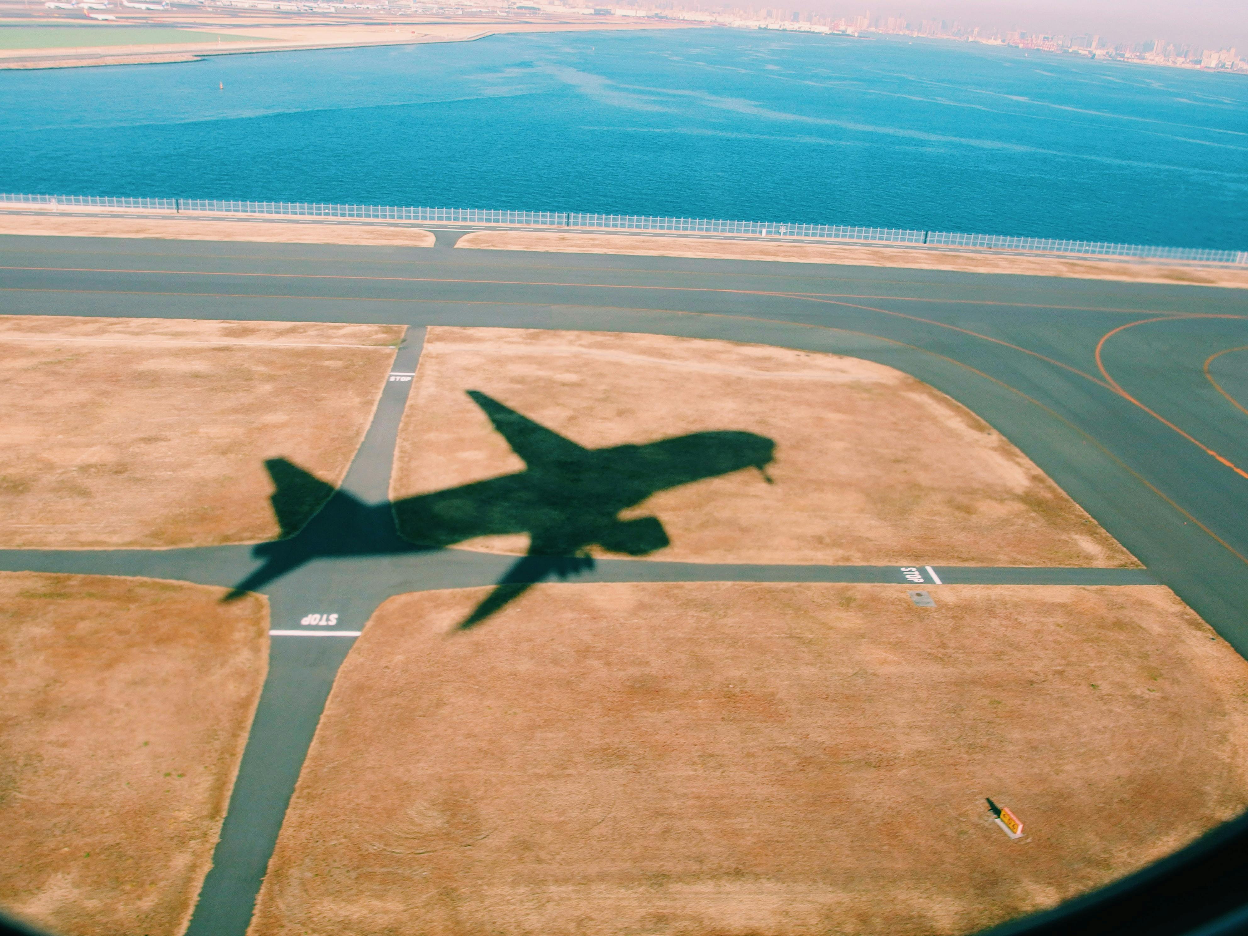 Shadow of plane on runway at Haneda Airport, Japan