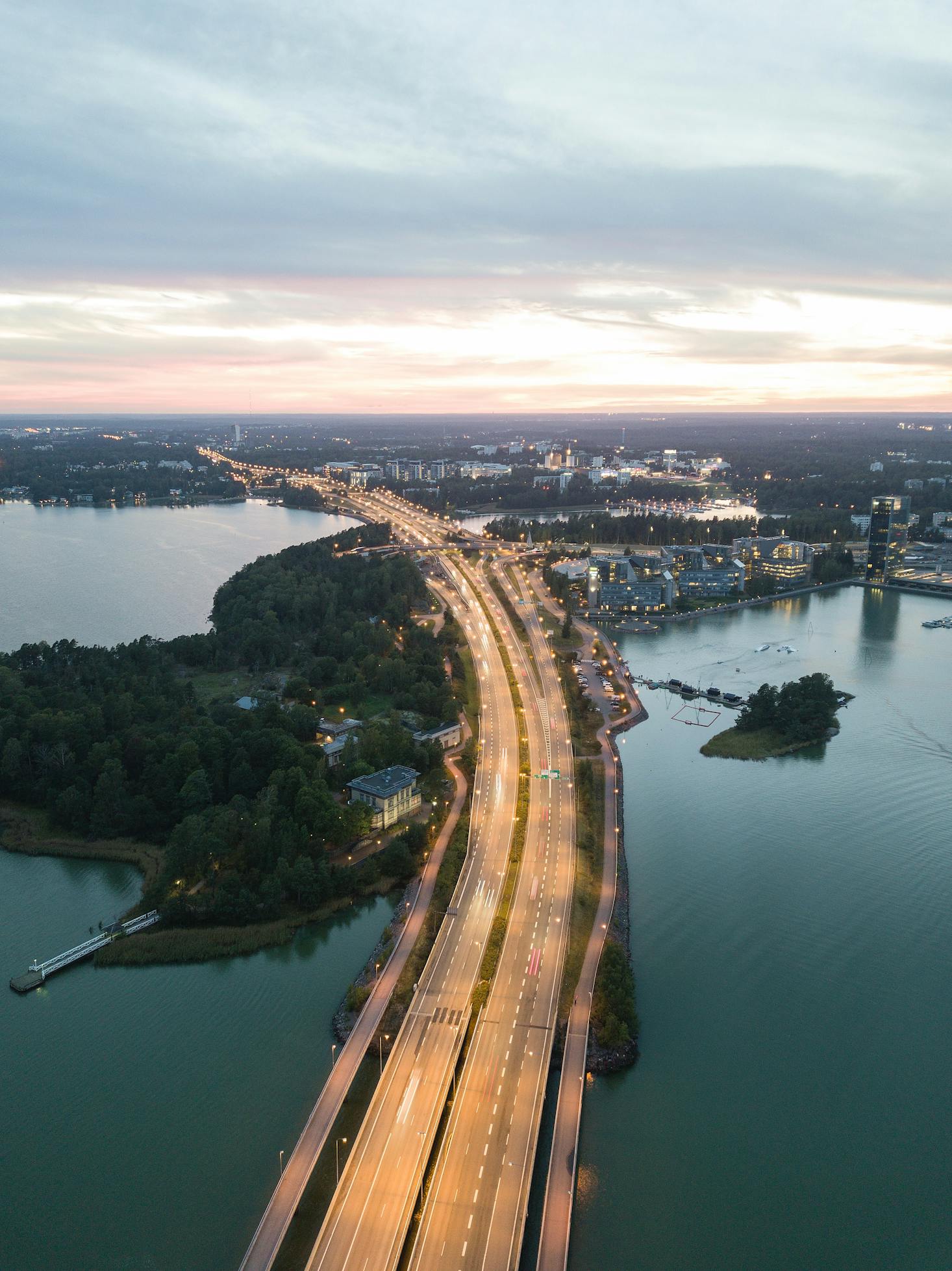 Highway entering Helsinki, Finland at night and surrounded by the Baltic Sea