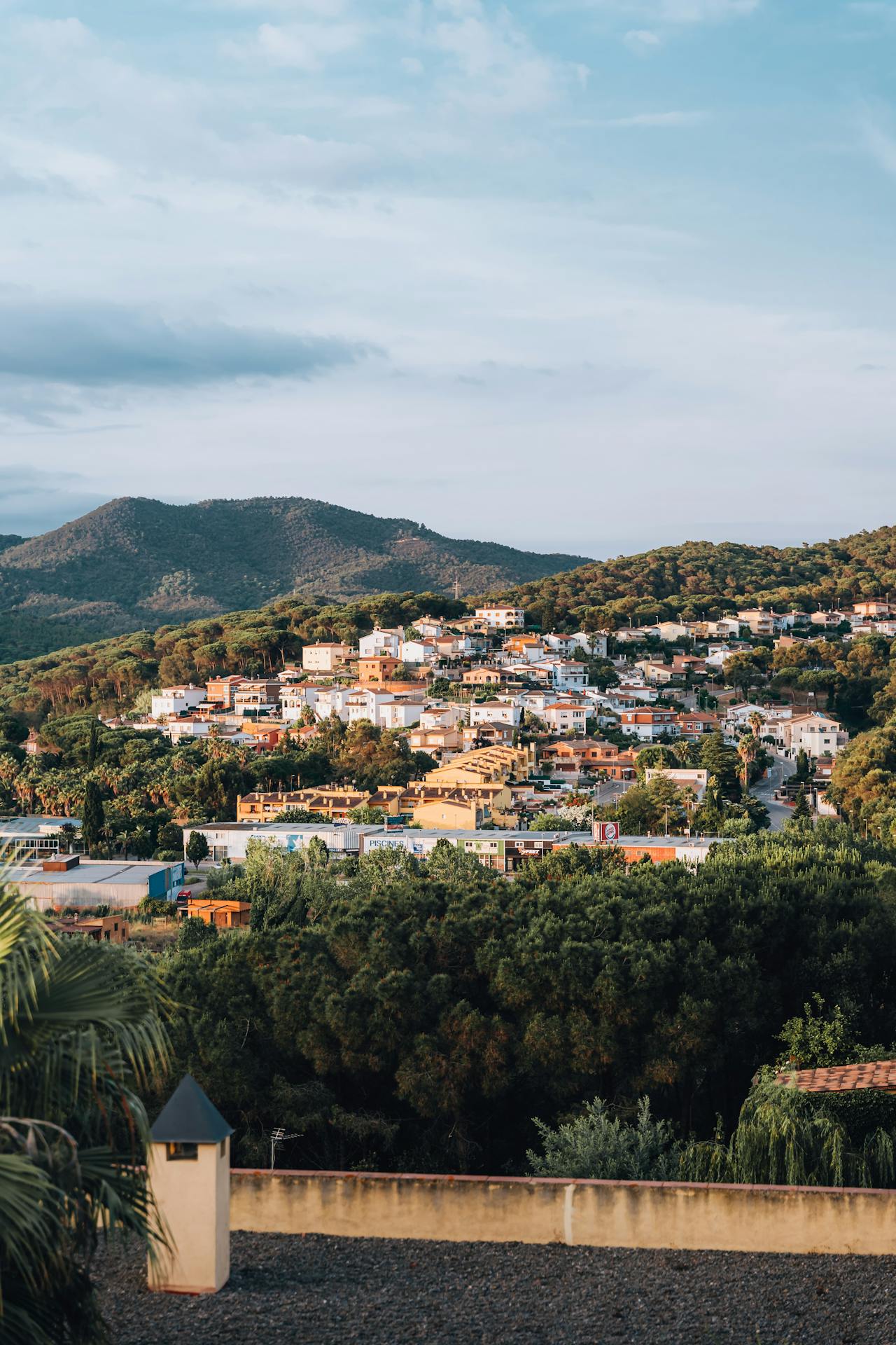 White houses fill the hillside overlooking water in Lloret de Mar, Spain