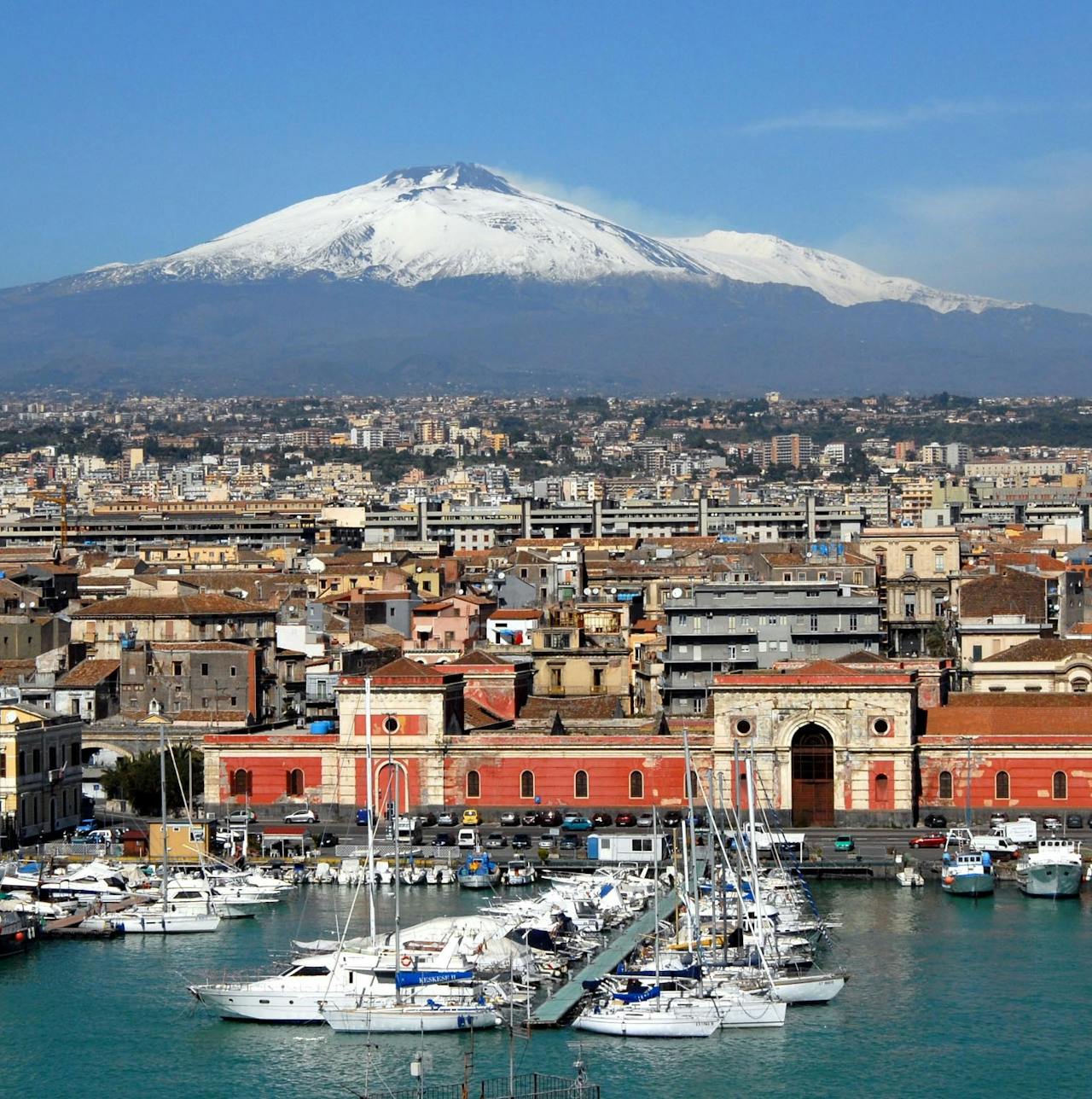 Luggage storage near the Catania waterfront with views of Mount Etna