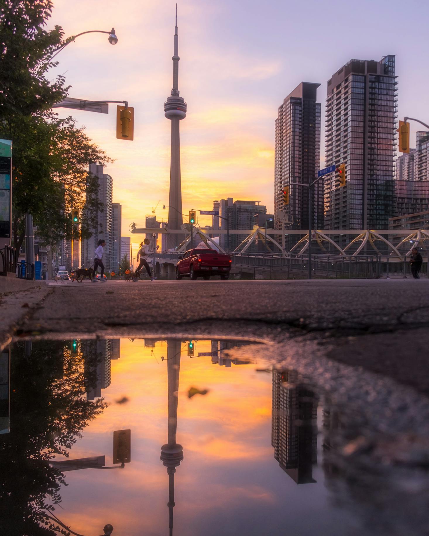 The CN Tower in Toronto reflected in the water at sunset