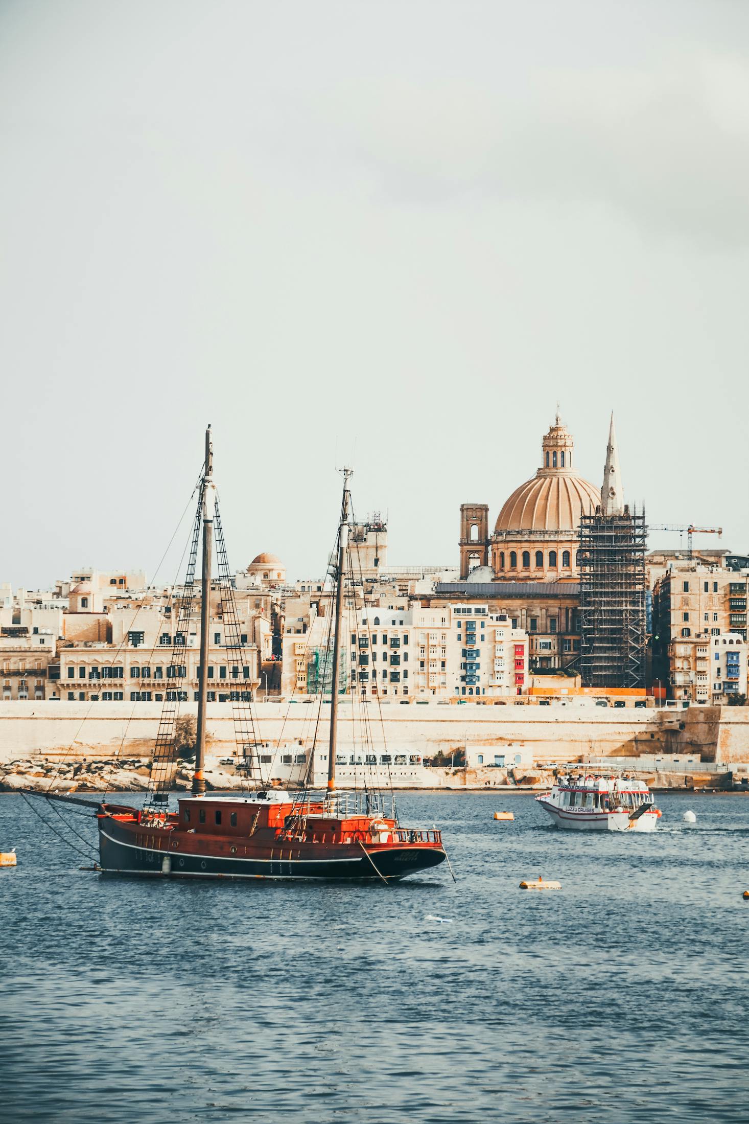 Limestone buildings of beautiful architecture overlook the harbor of Valletta, Malta