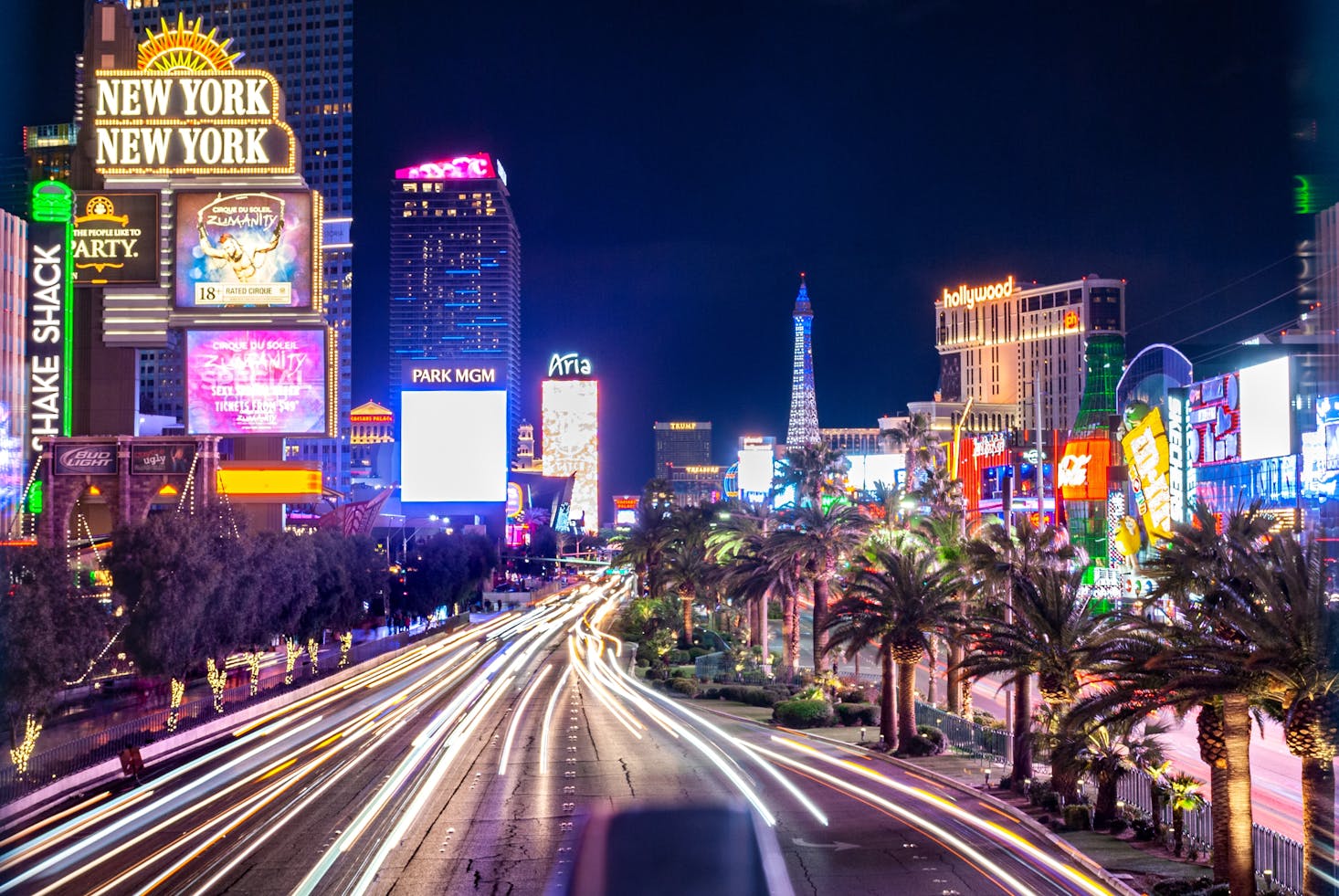 The Strip, Las Vegas with neon lights and fast motion car light trails