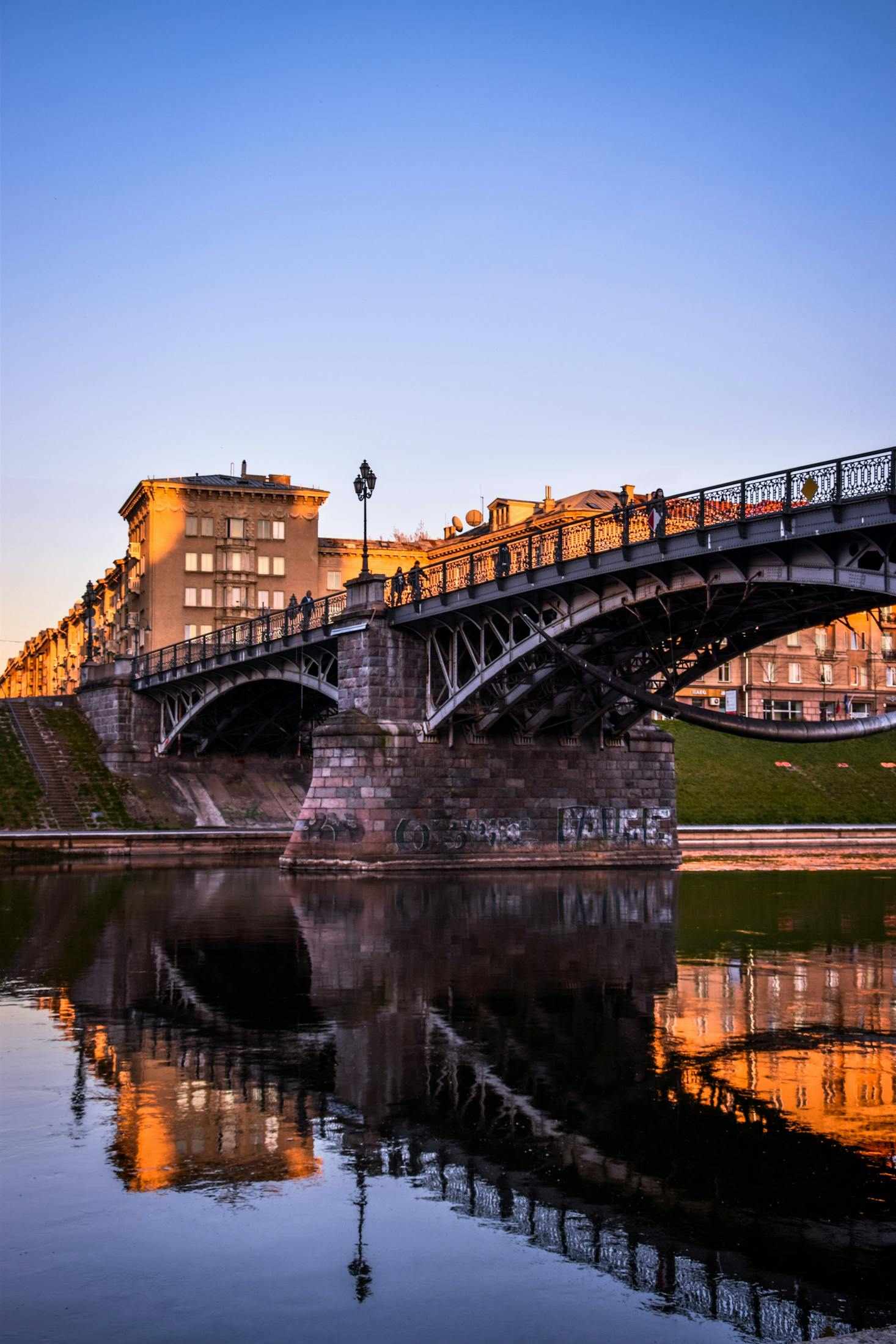 Bridge over calm water on a sunny day in Vilnius, Lithuania