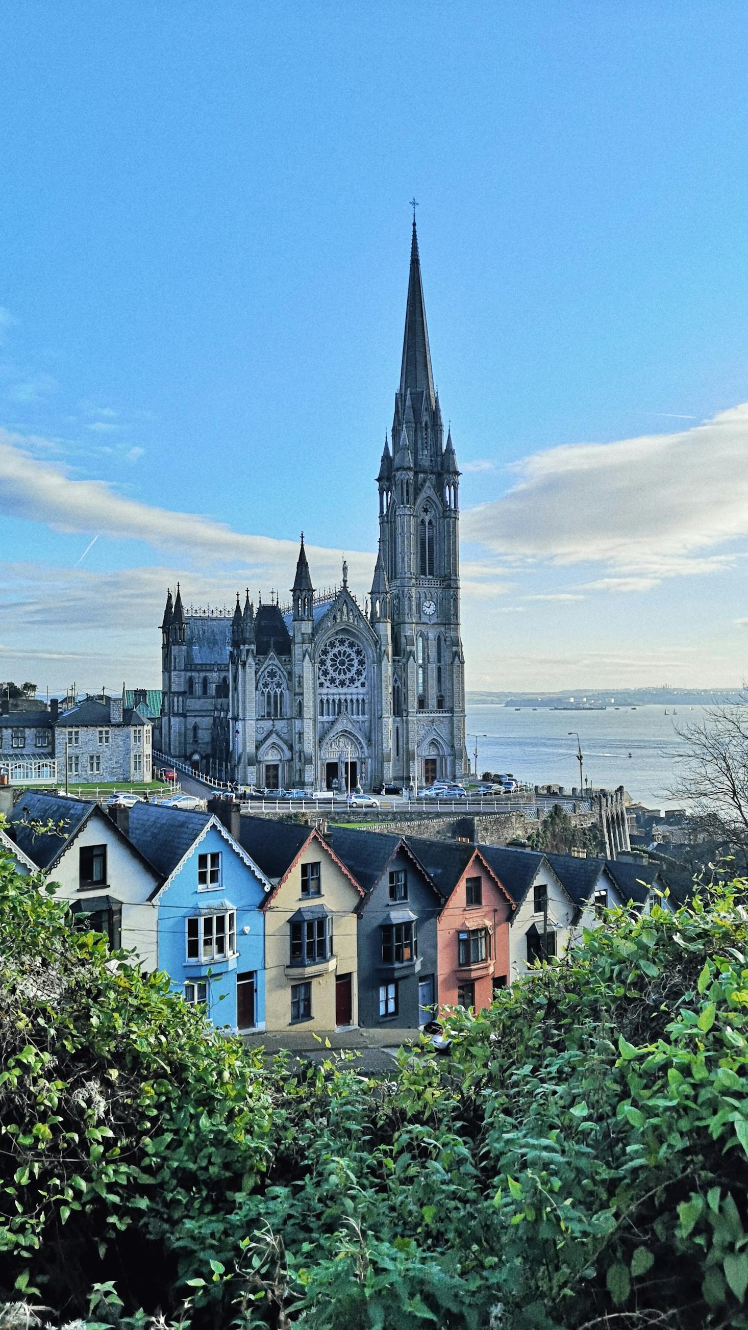 View of Cork Cathedral in the background and colorful houses in the foreground 