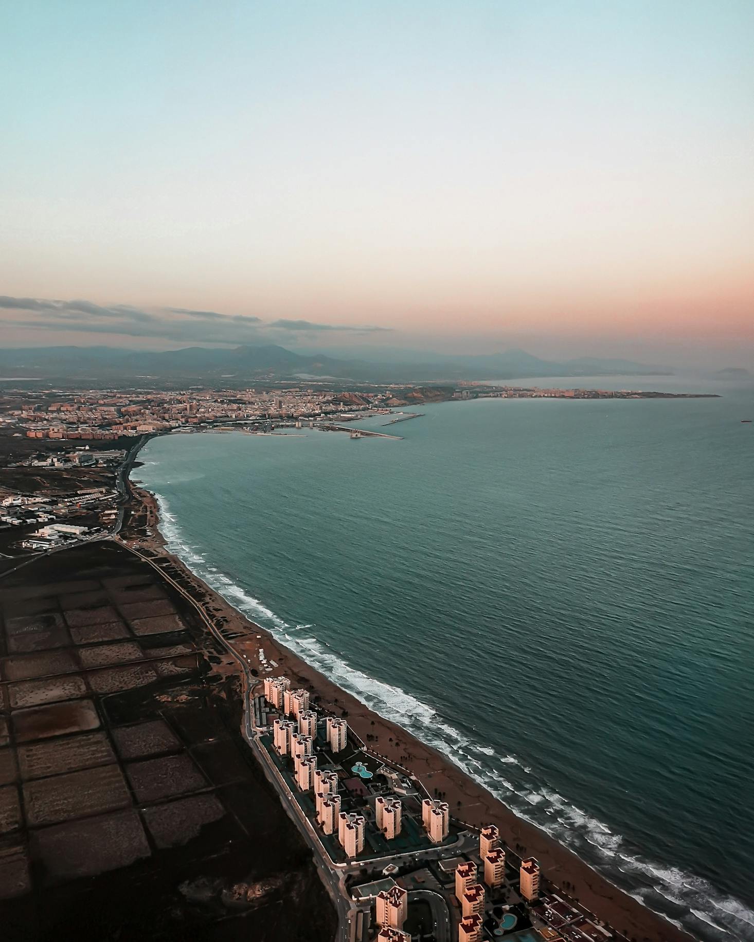 The coastal city of Alicante looks over the Mediterranean Sea at sunset