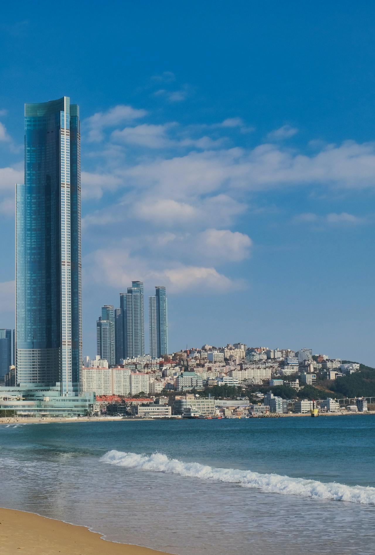 The beach in Busan with skyscrapers in the distance