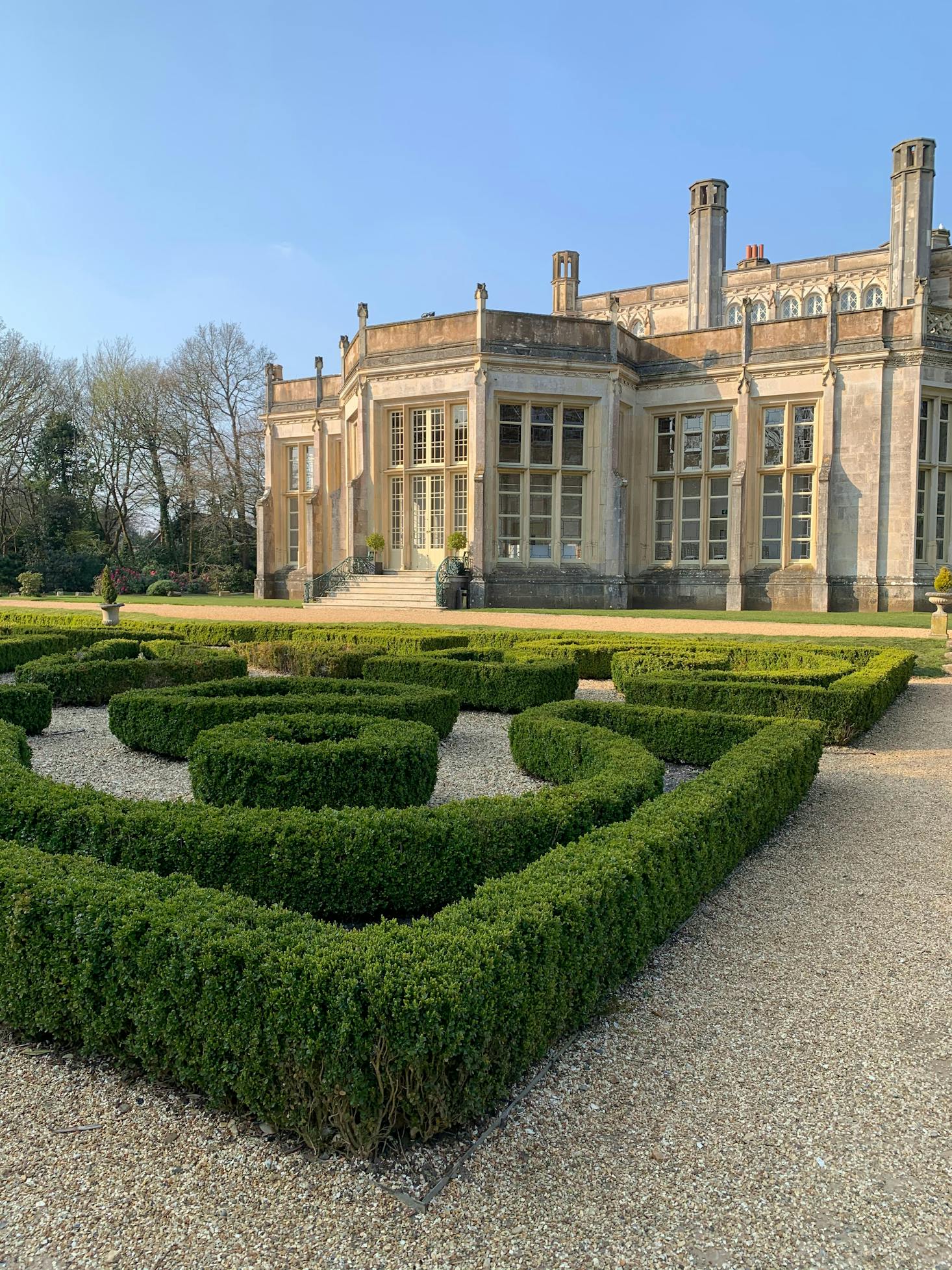 Manicured green hedges and a brown building in Christchurch