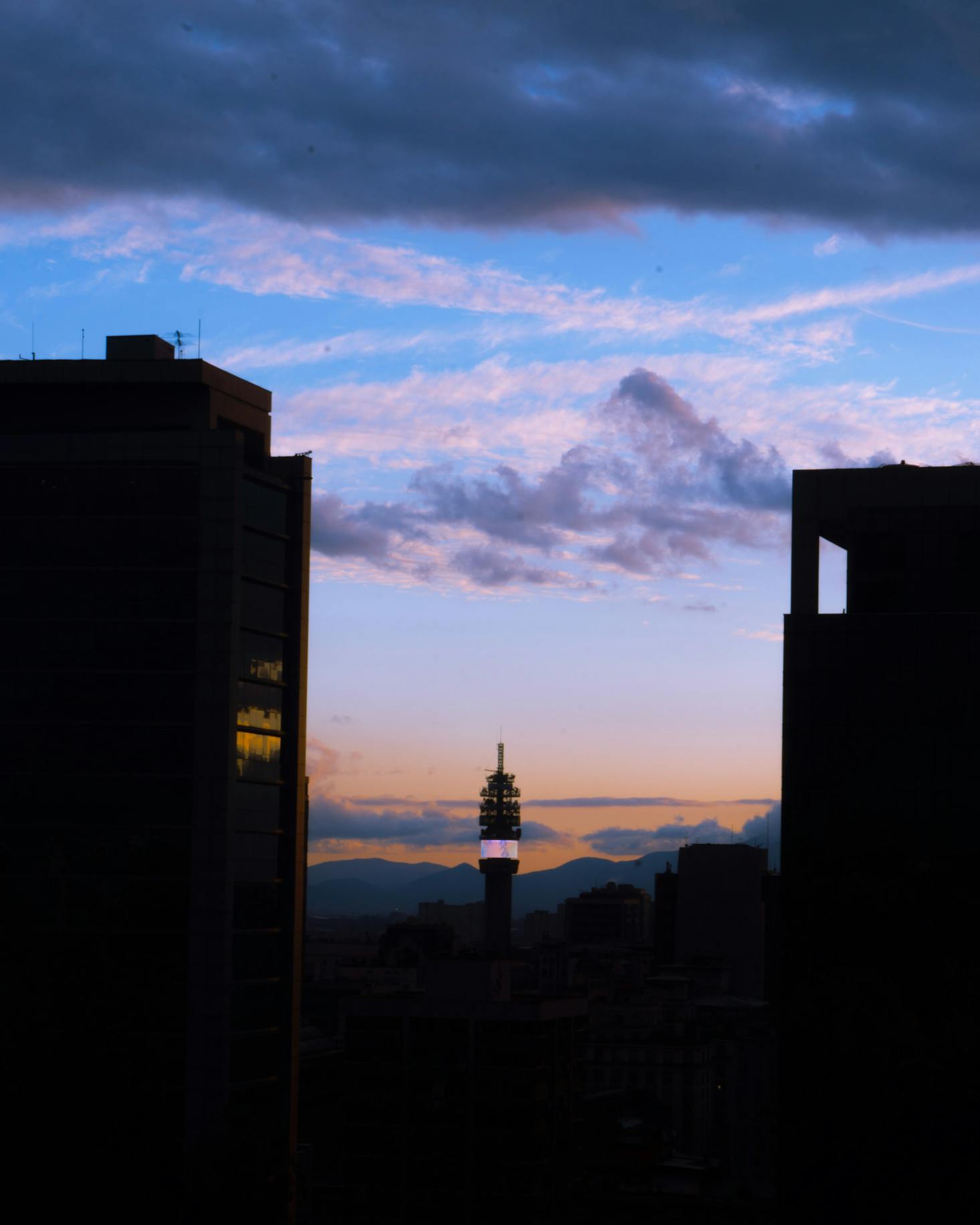 Buildings in Santiago, Chile silhouetted against a sunset