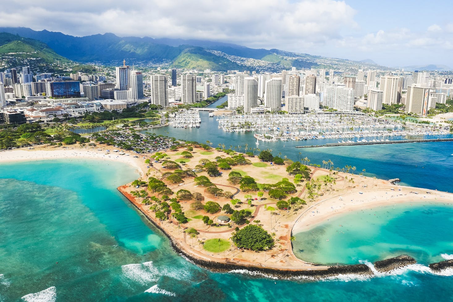 Aerial view of the clear water, beaches, and large hotels in Honolulu