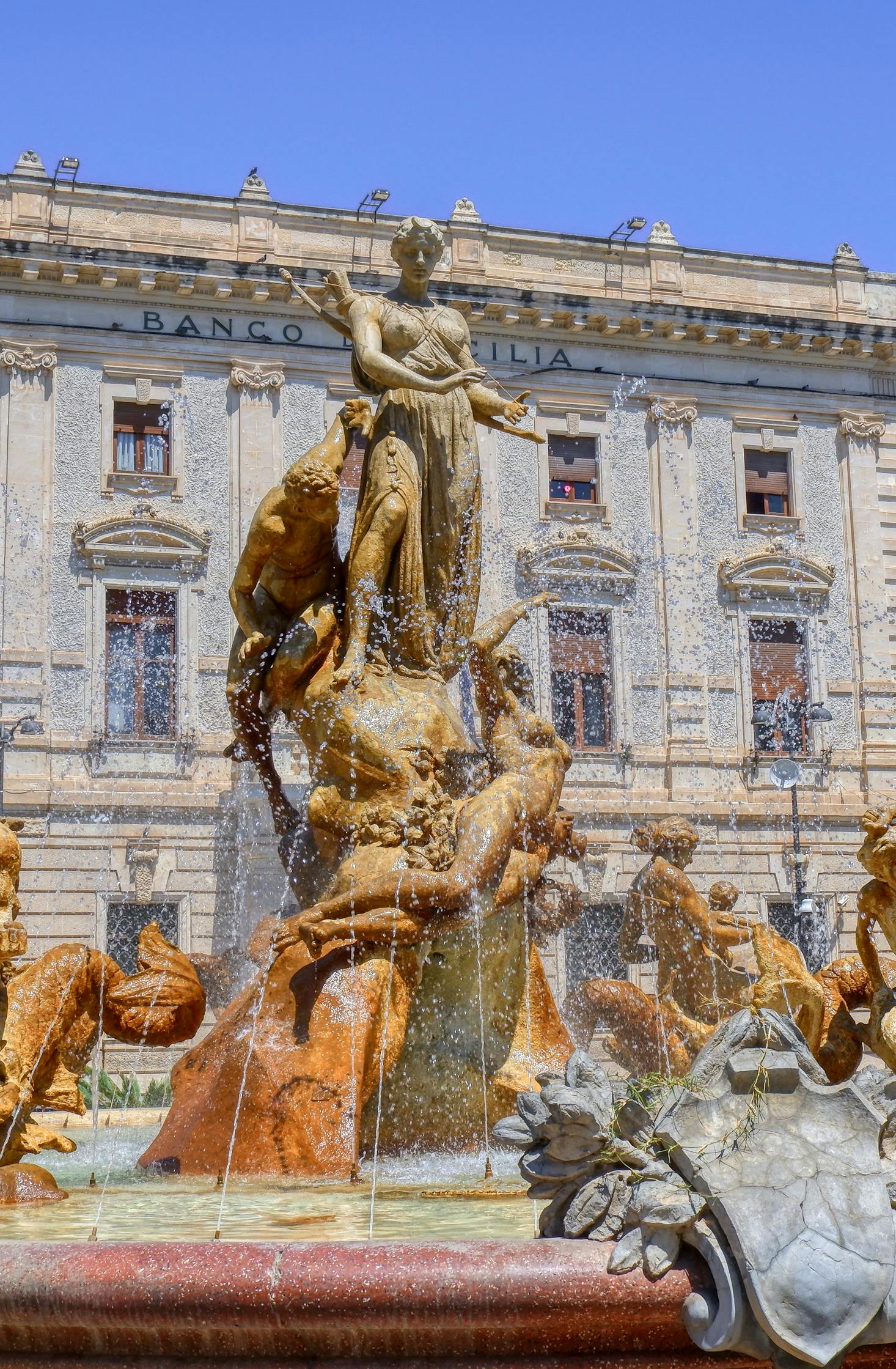 Ornate gold fountain in a square in Siracusa, Sicily