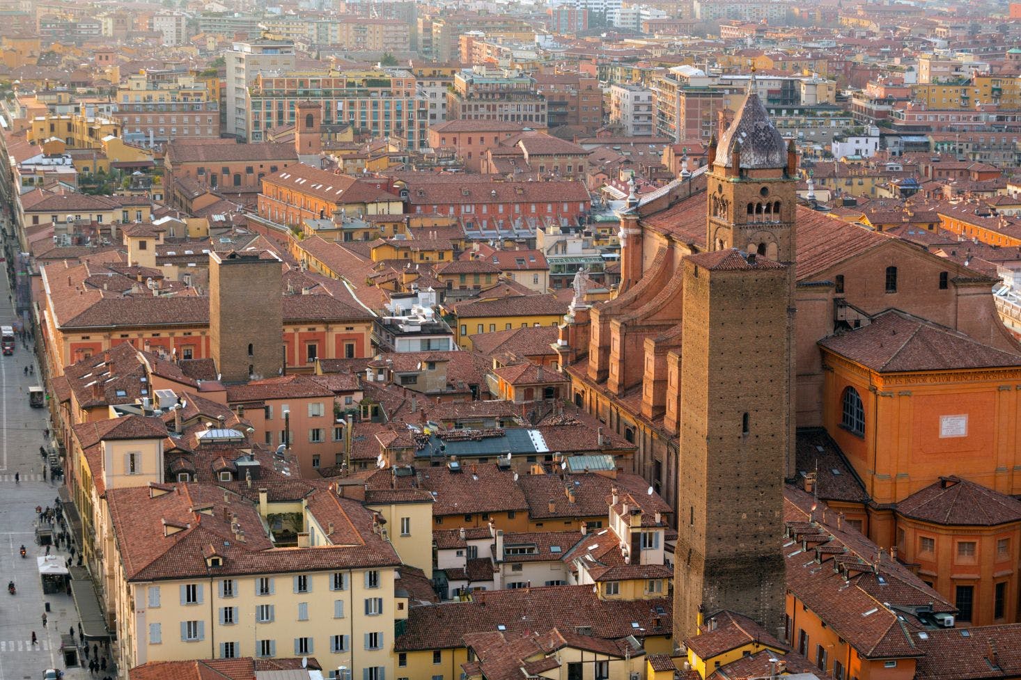 View of Bologna's orange-hued historic center with the iconic Cathedral and city skyline stretching into the distance