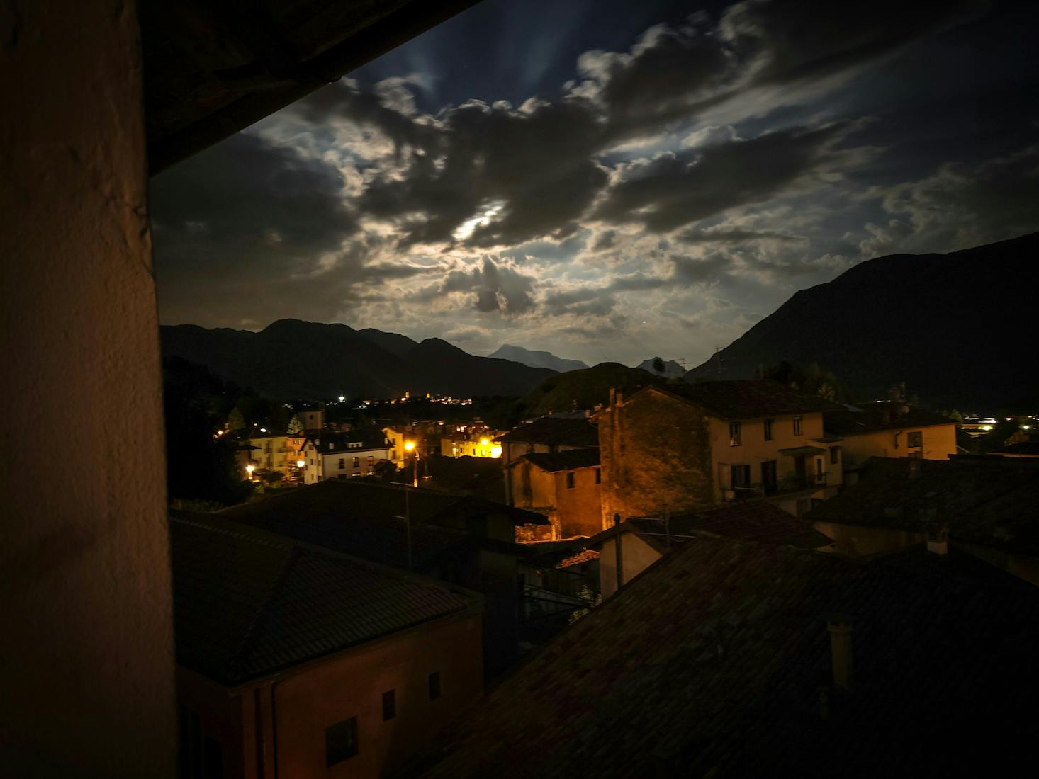 Historic Old Town of Bergamo at night through an open window