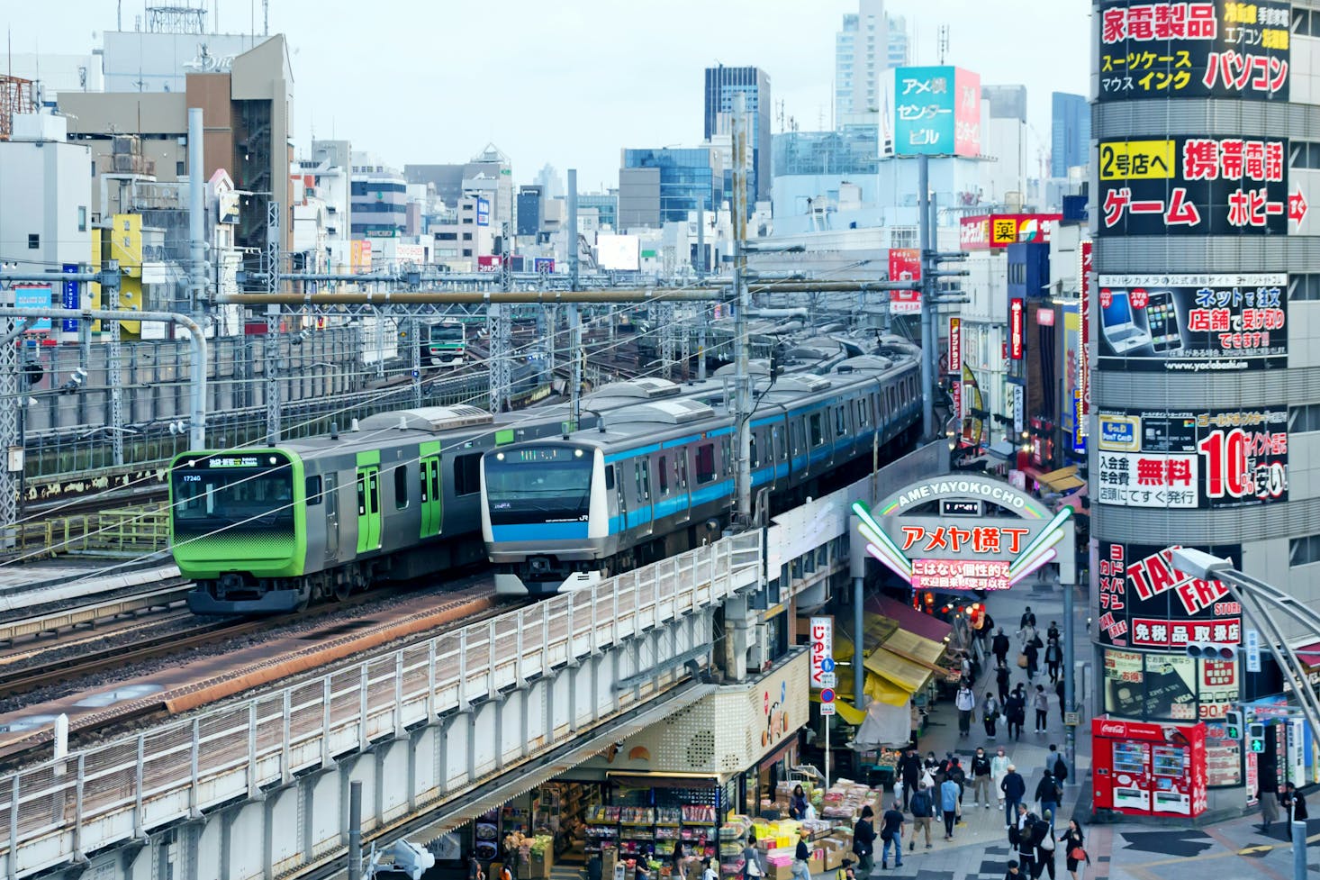 Two trains on the tracks above the city streets near Okachimachi Station in Tokyo