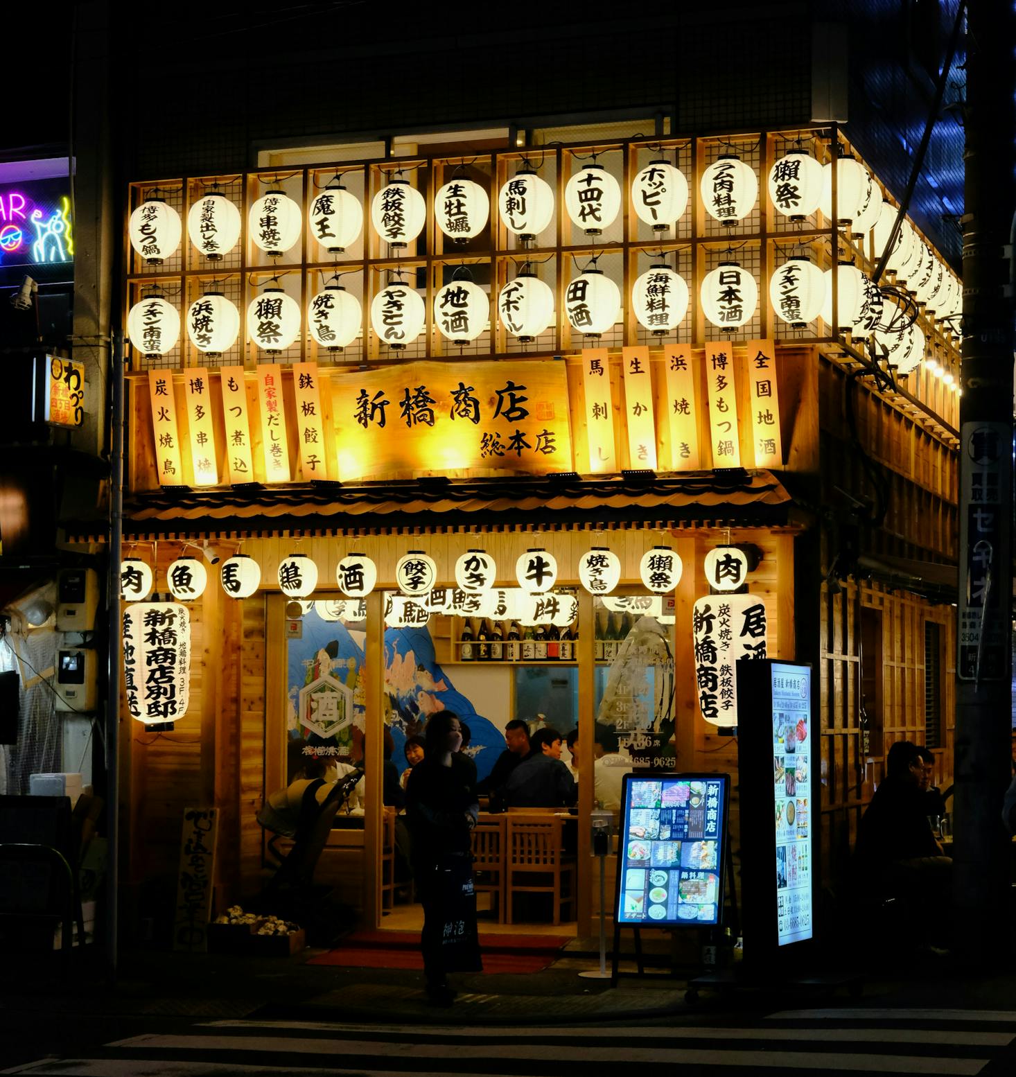 A small restaurant lit up with many lanterns in Tokyo's Shinbashi neighborhood