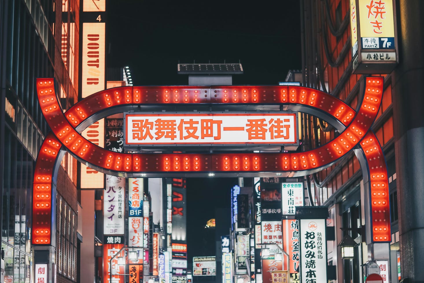 Bright red lights and signs in the Kabukicho neighborhood of Tokyo at night