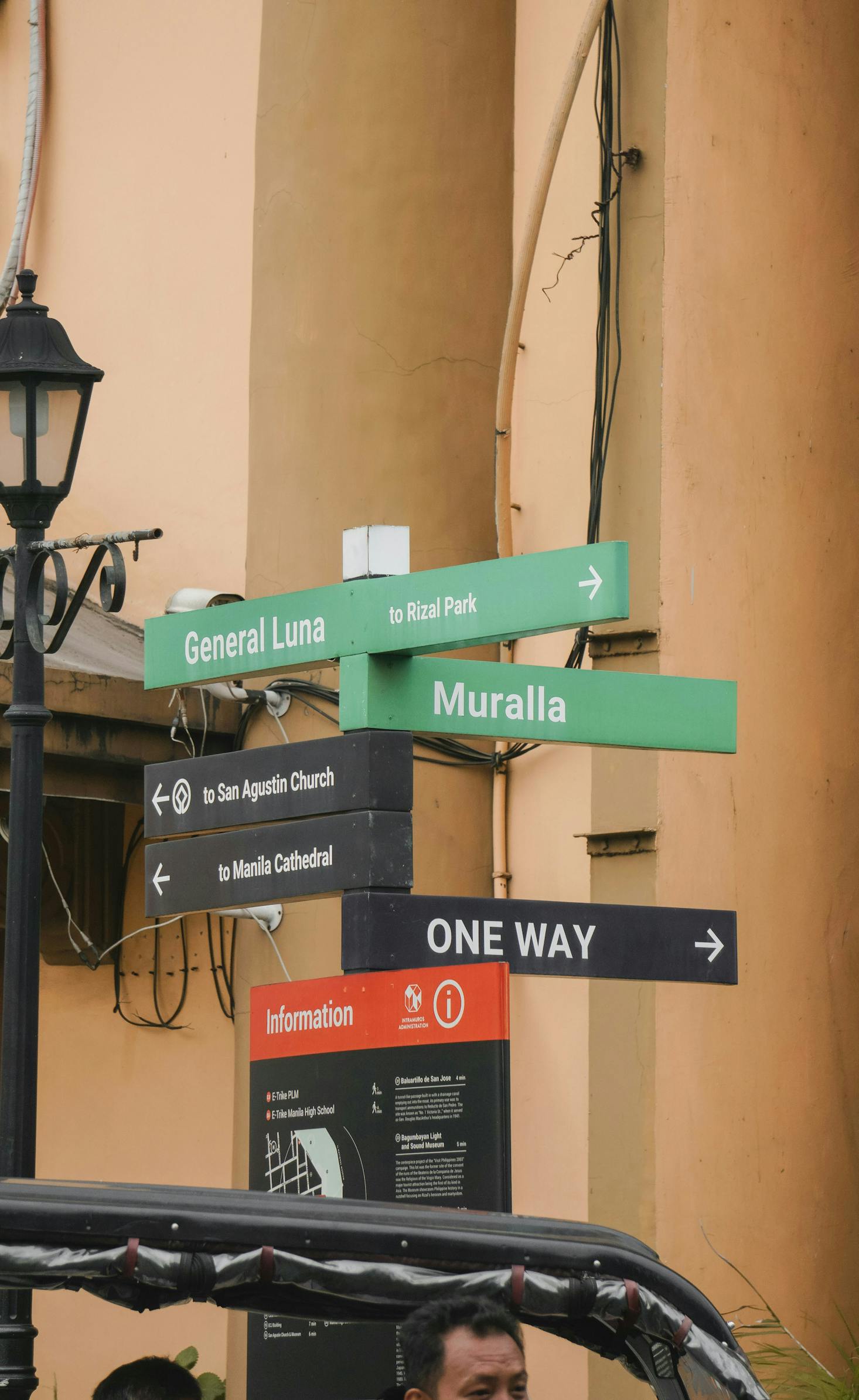 A street corner with multiple road signs in Intramuros in Manila