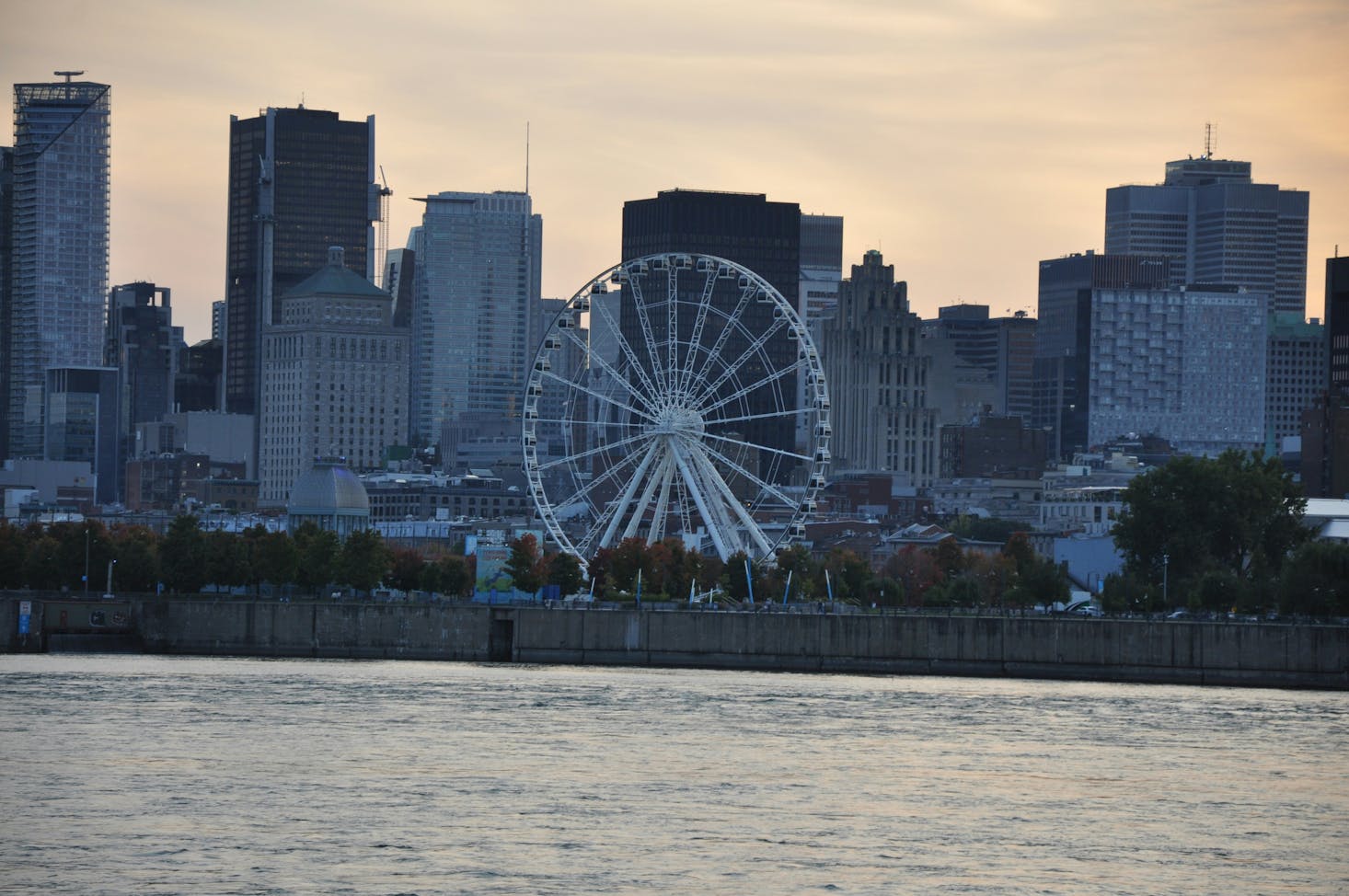 The Montreal waterfront at sunset with a prominent Ferris wheel