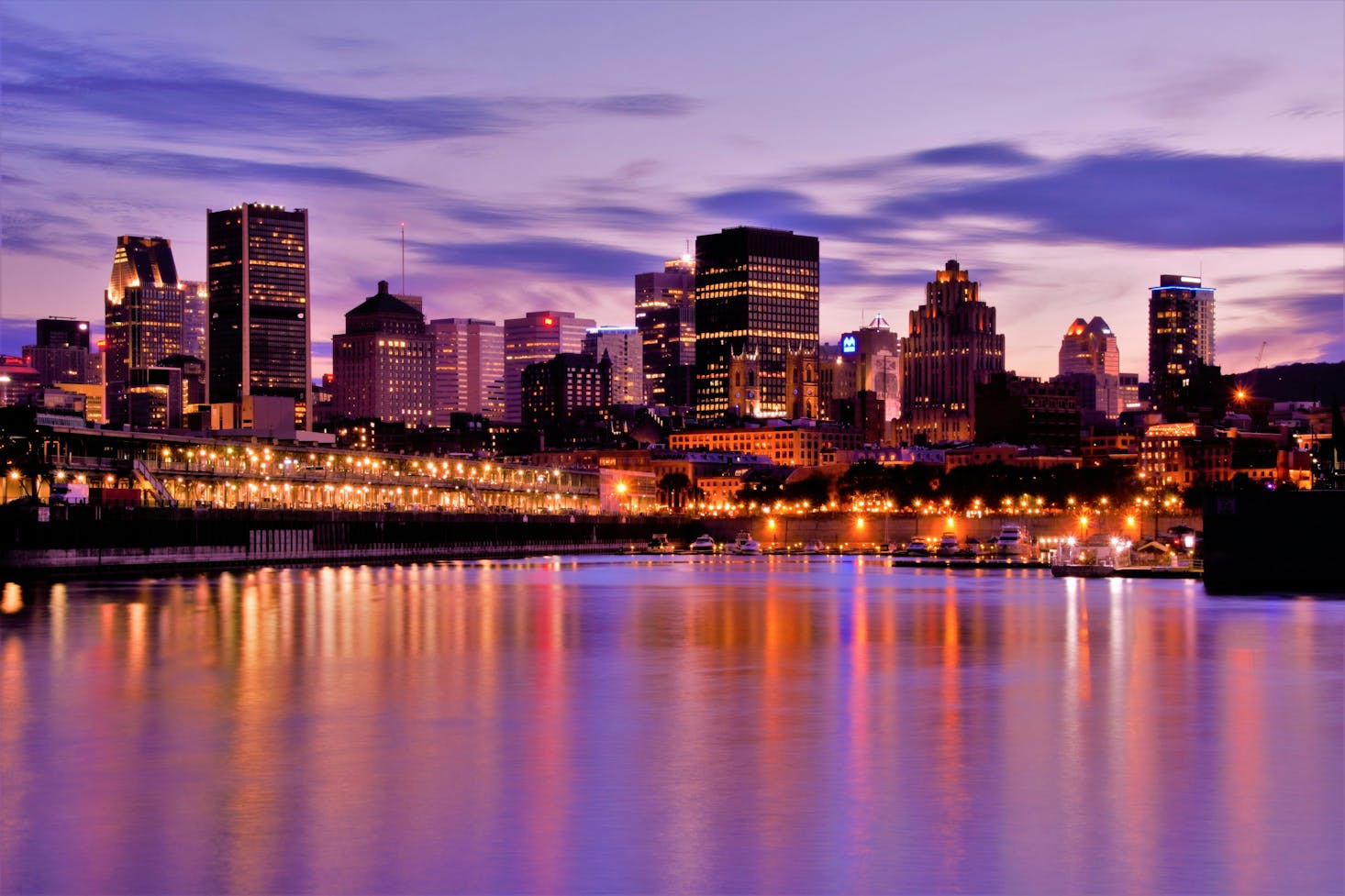 Sunset from the waterfront in Montreal with orange and purple light reflecting