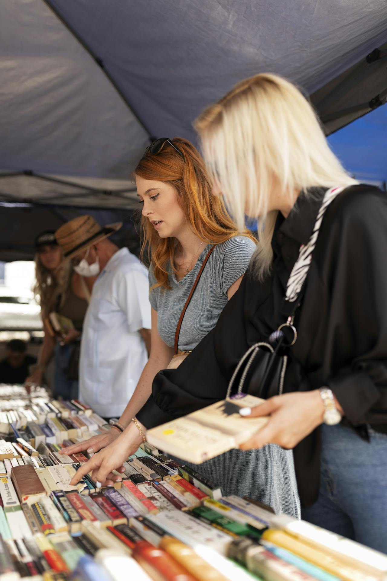 Visitors browsing and engaging at a market stall