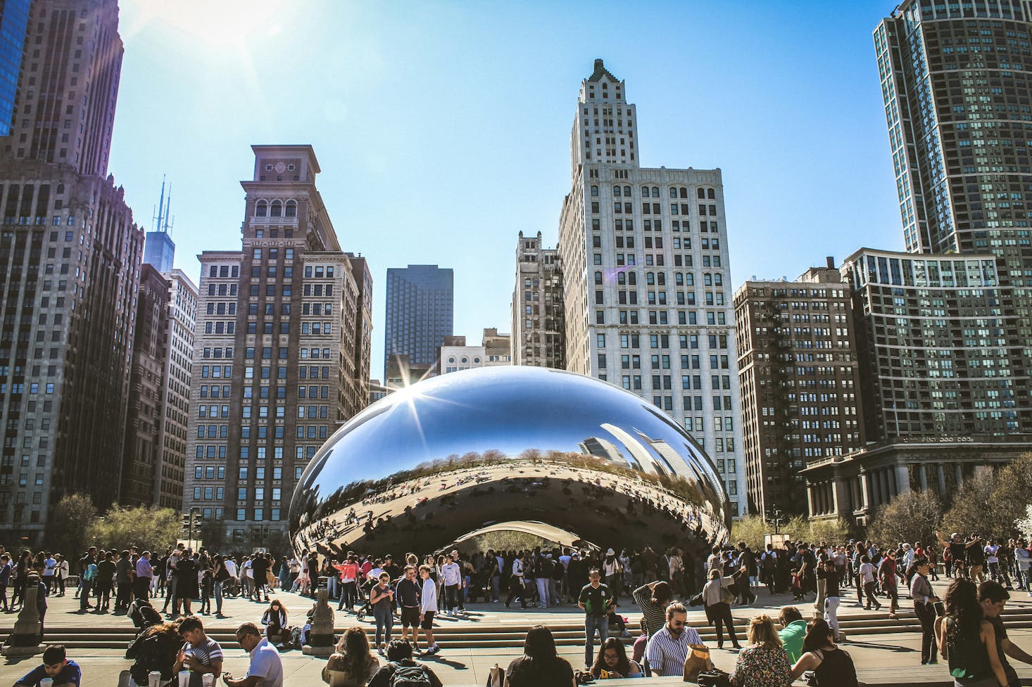 The bean-shaped sculpture surrounded by tall buildings in Chicago's Millennium Park