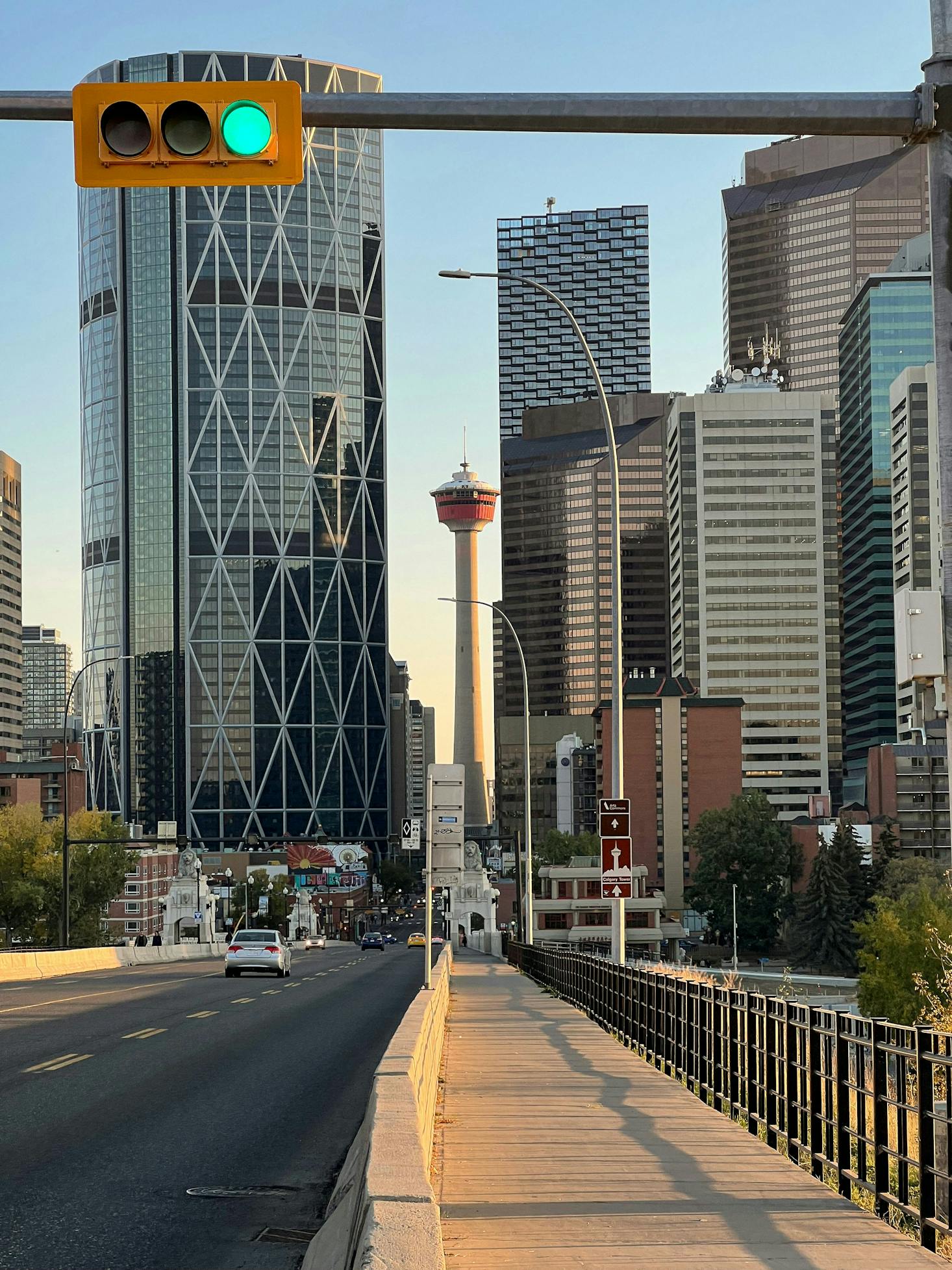 The Calgary Tower in the distance between two large buildings