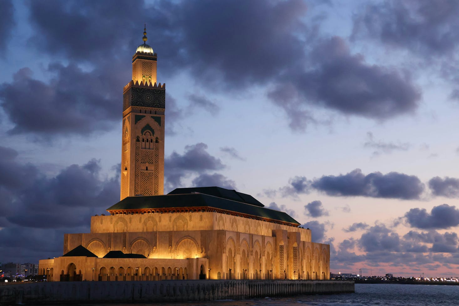 The stunning Hassan II Mosque lit up just after sunset in Casablanca