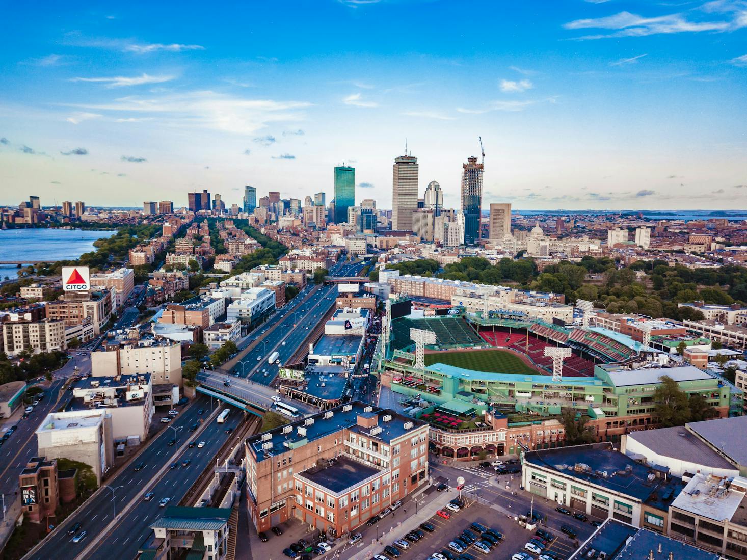 Aerial view of Boston with the harbor, stadium, and tall buildings