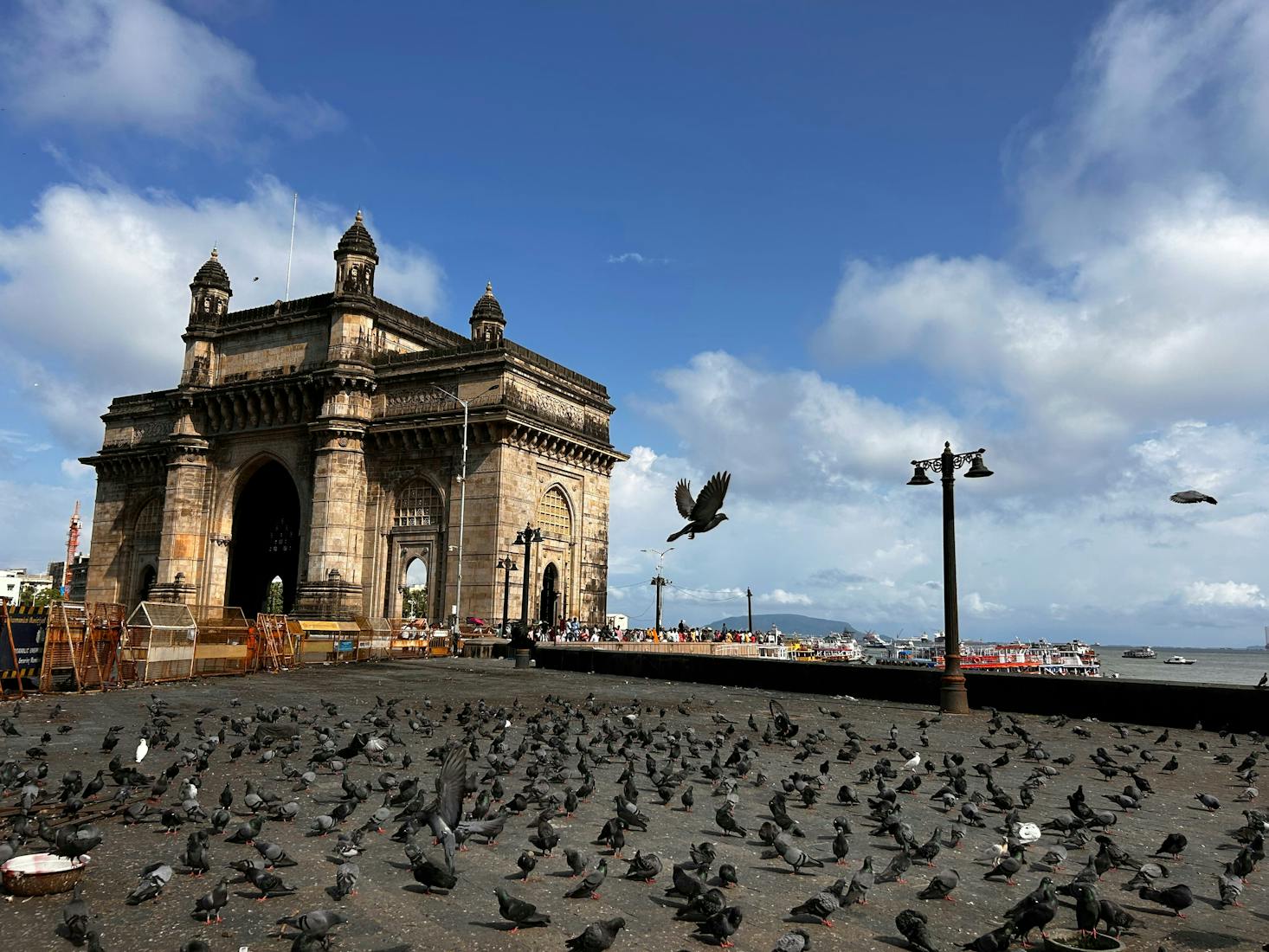 The Gateway of India in Mumbai with many pigeons in the foreground