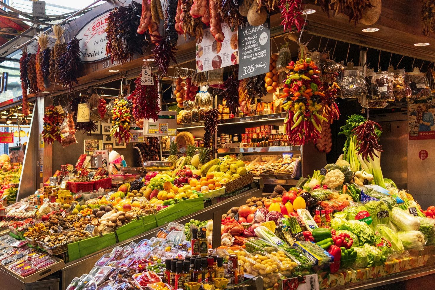 La Rambla market in Barcelona with fresh, colorful produce, vegetables, fruits, spices and sauces