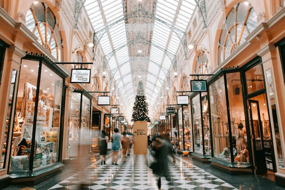 Block Arcade in Melbourne with checkered floors, Christmas decorations, and shoppers walking quickly through the mall