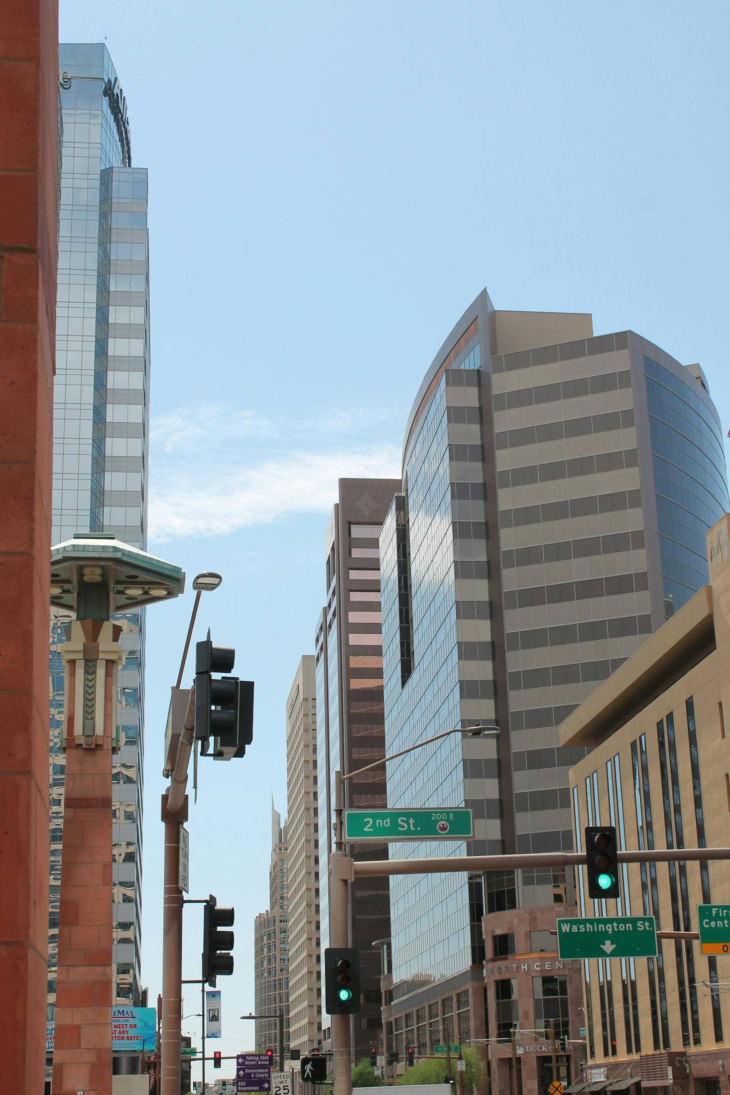 A traffic light surrounded by skyscrapers in downtown Phoenix