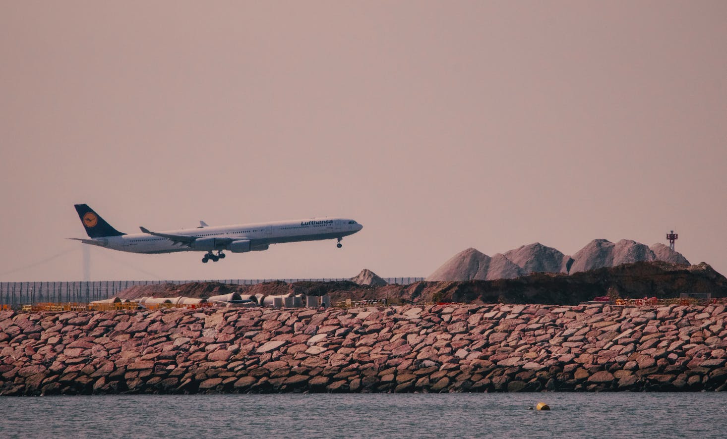 Plane taking off from Hong Kong Airport at sunset