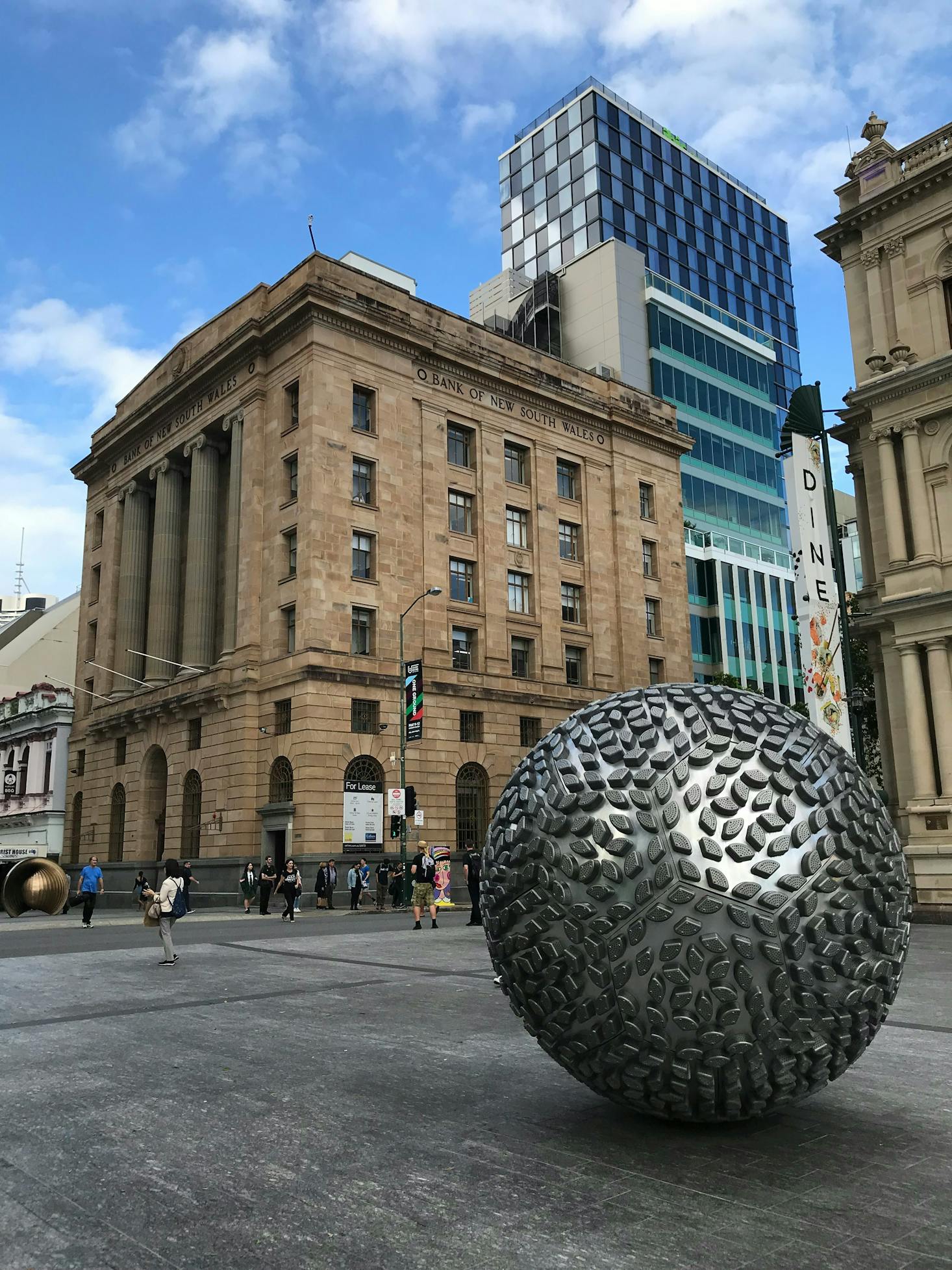 A round sculpture in front of a bank building in Brisbane