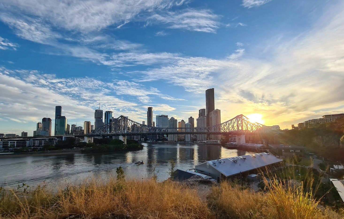 The Brisbane CBD and the Story Bridge as the sun starts to set over the river