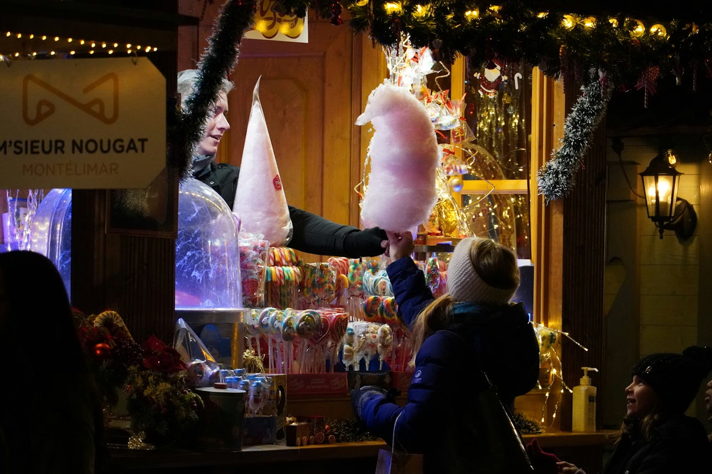 A child buying candy at a Christmas market in Geneva