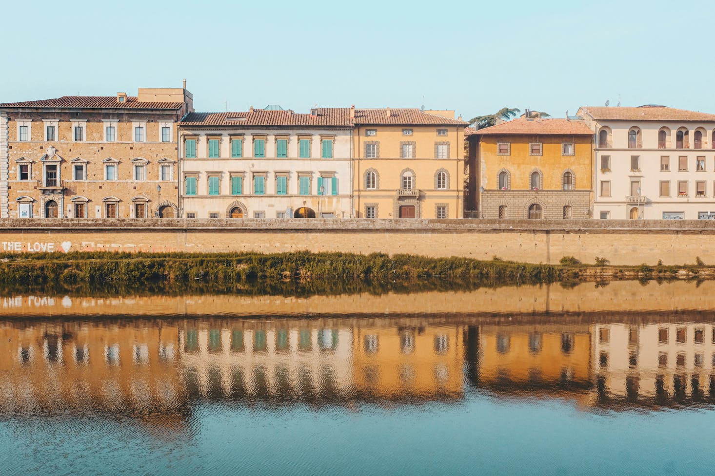 Historic buildings along the Arno River in Pisa