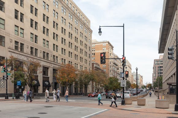 Washington DC street busy with cars and people crossing the road