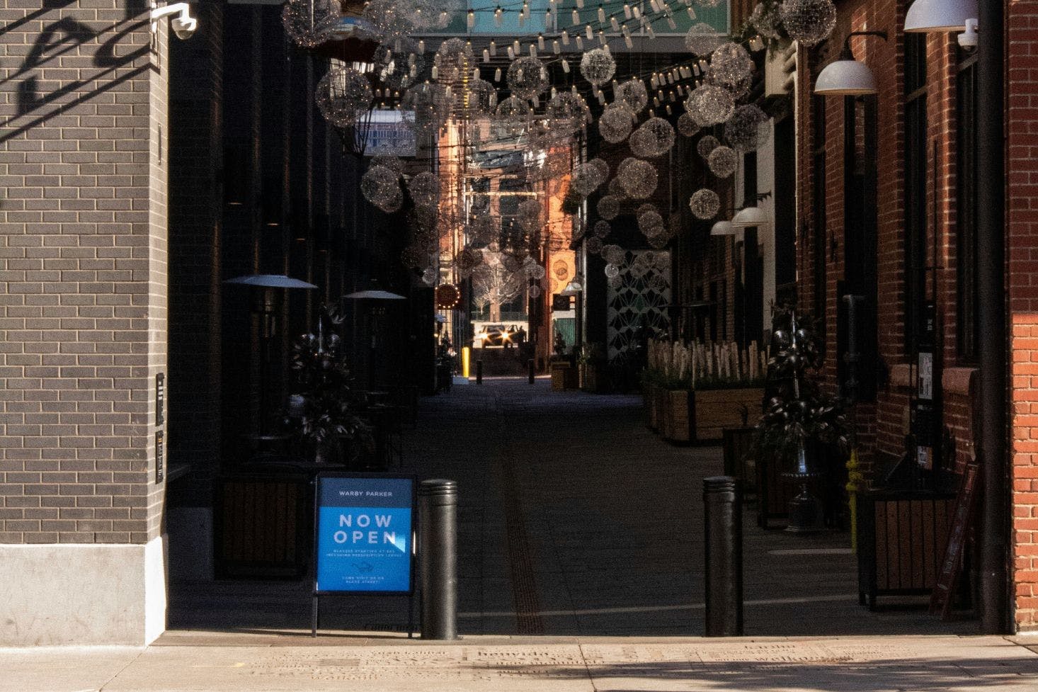 A market on Dairy Block Avenue in Denver with passageway and sparkling decorative lights hanging above