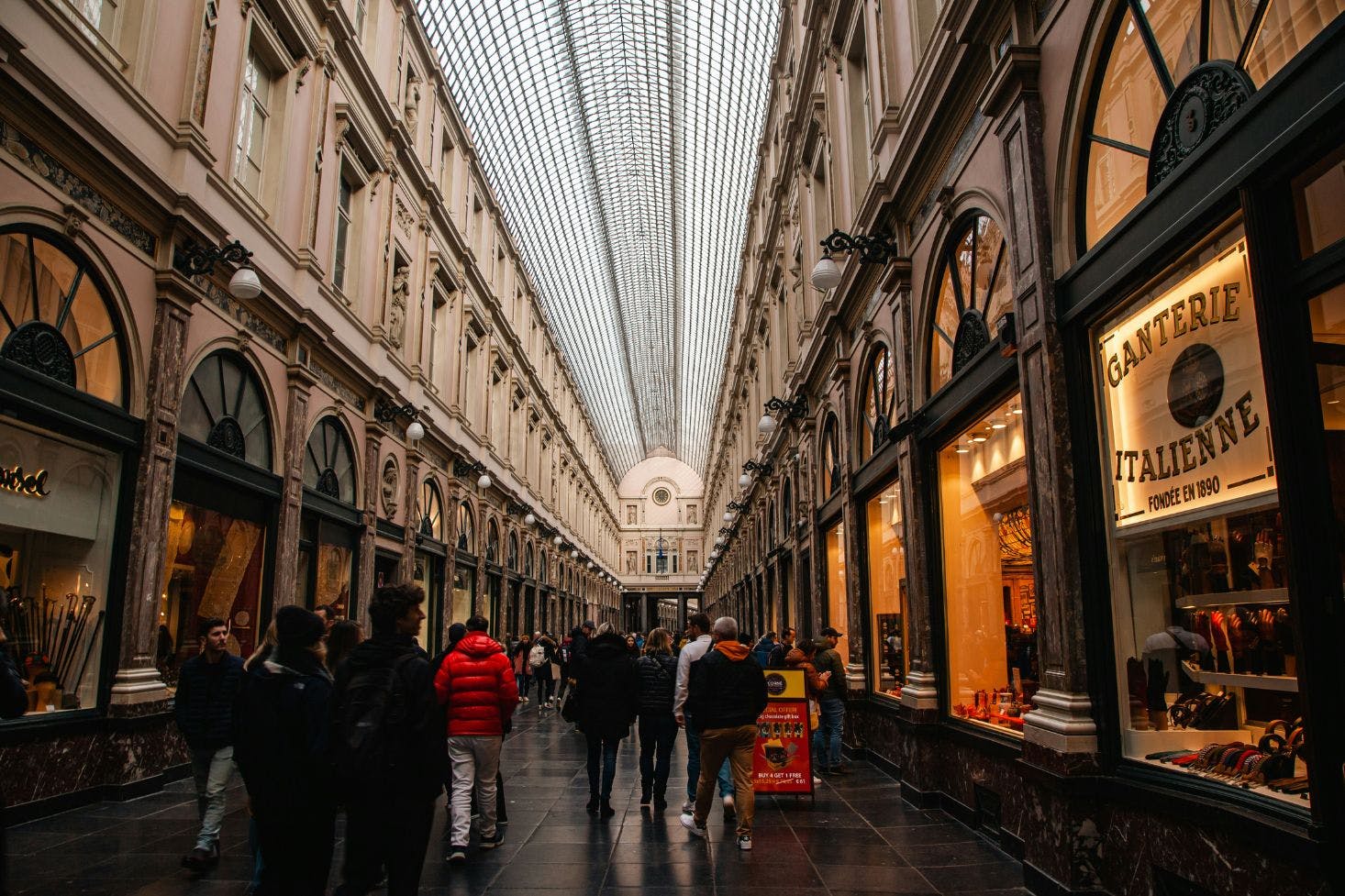 Arcade, Galeries Royales Saint-Hubert in Brussels, with arched dome and details and busy shoppers walking through the hallway