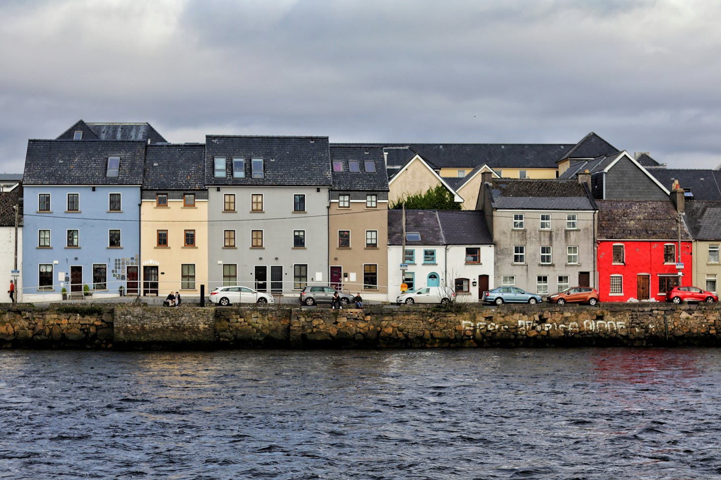 A row of colorful houses by the water in Galway, Ireland