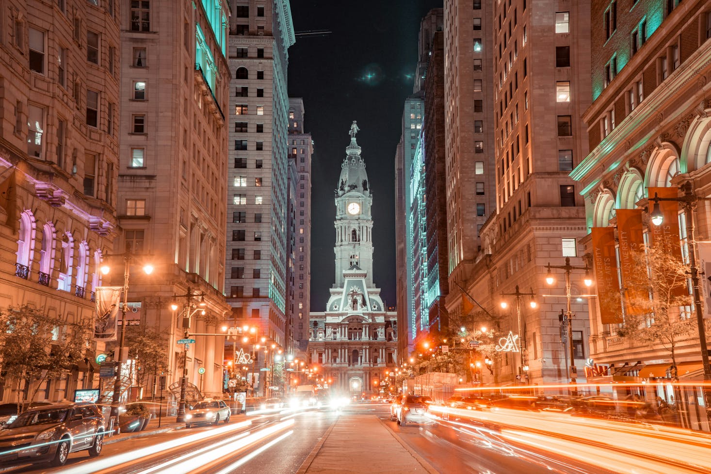 Light streams from car's headlights in downtown Philly at night