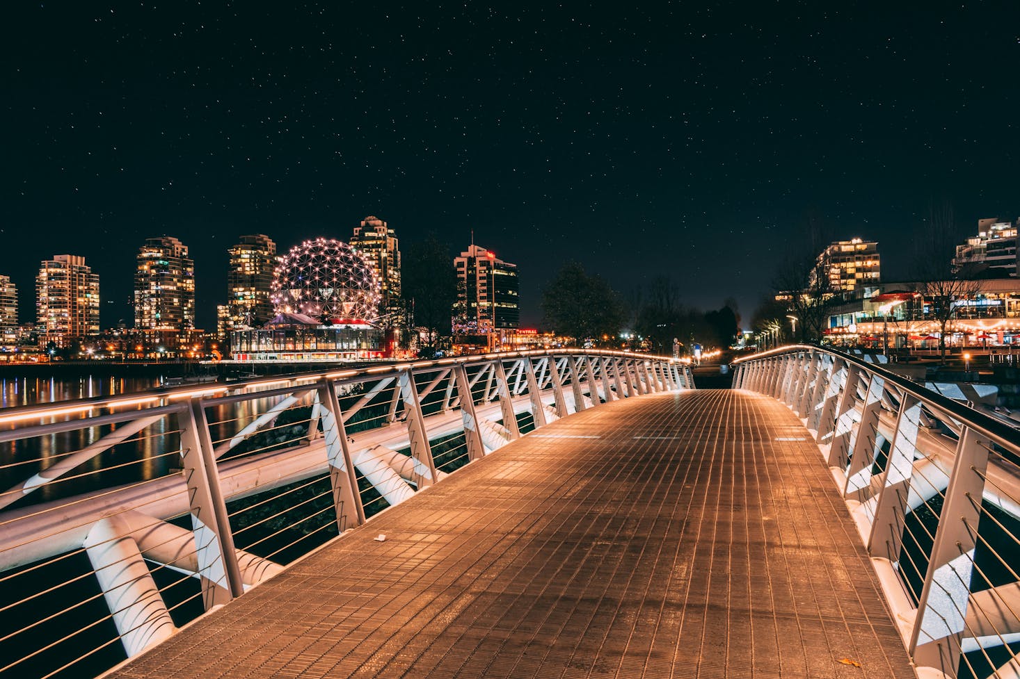 Well-lit footbridge in Vancouver over False Creek at night