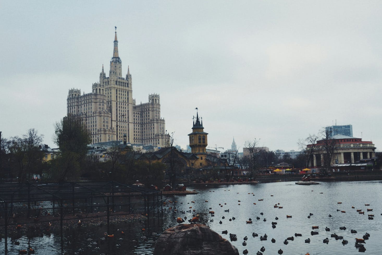 A large building beside a pond on a gloomy day in Moscow