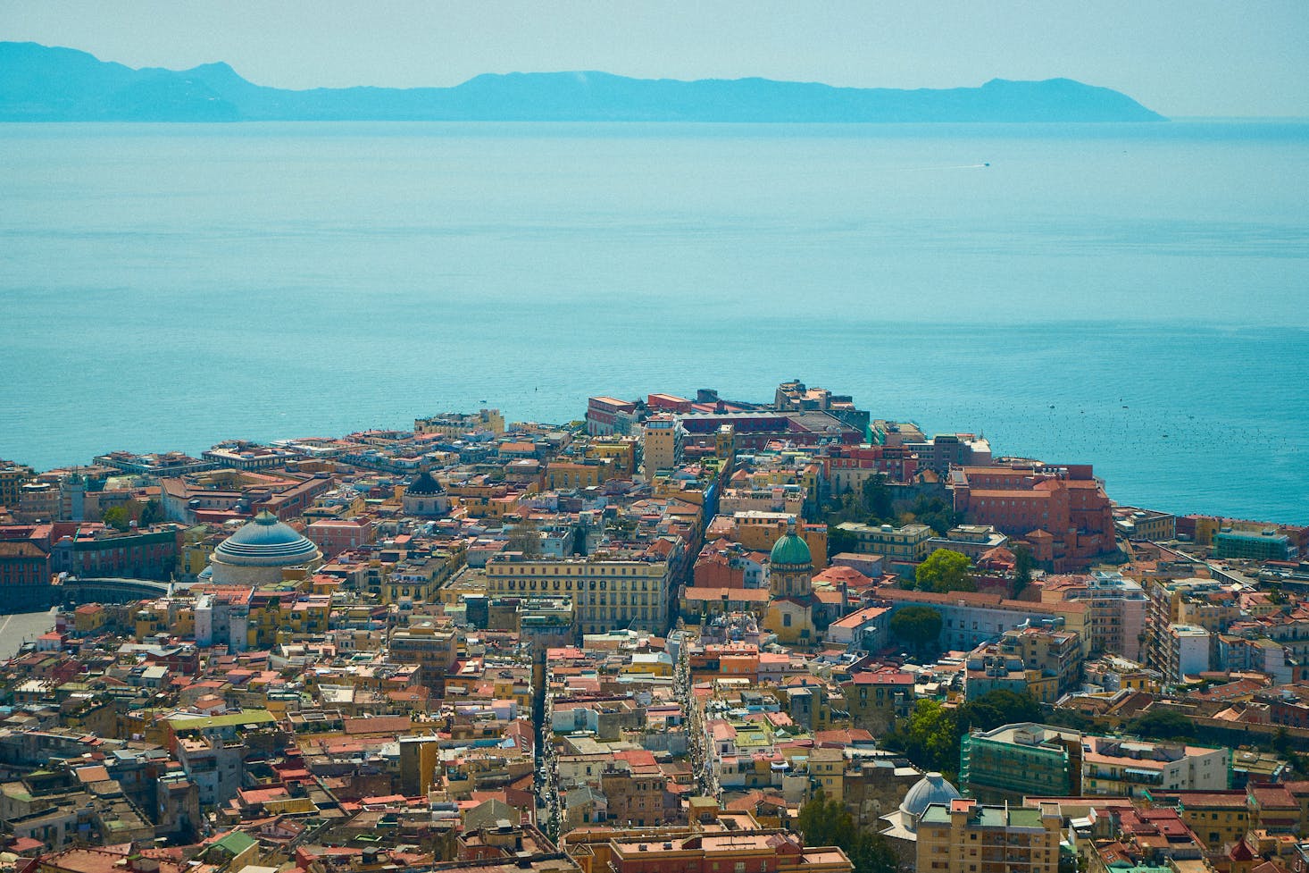 Aerial view of Naples, Italy, with rooftops and the sea