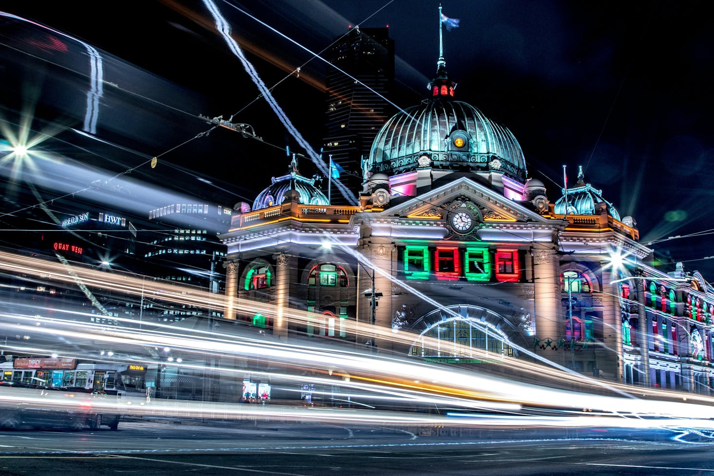 Long exposure of car lights in front of Flinders Street Station in Melbourne at night