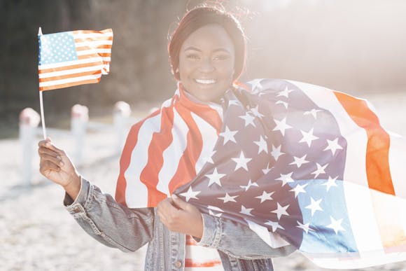 A vibrant celebration of unity and equality, featuring a participant wrapped in the American flag